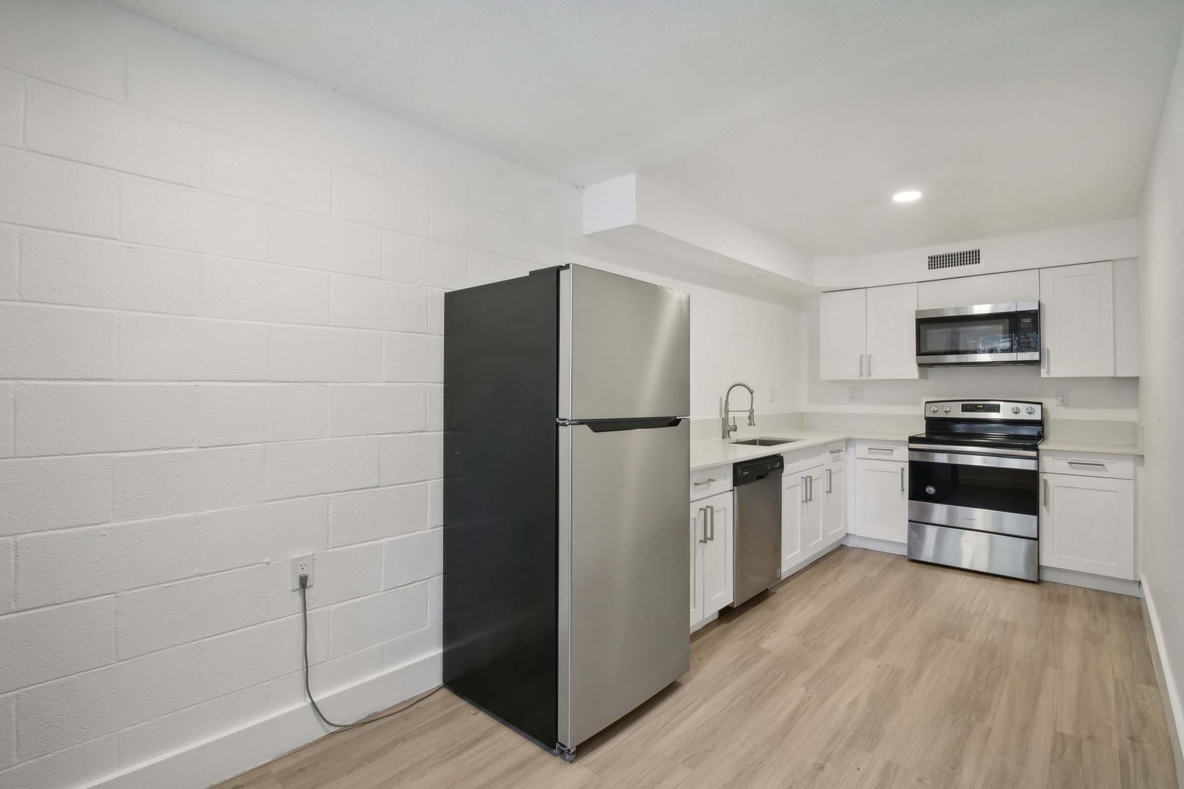 a large kitchen with stainless steel appliances