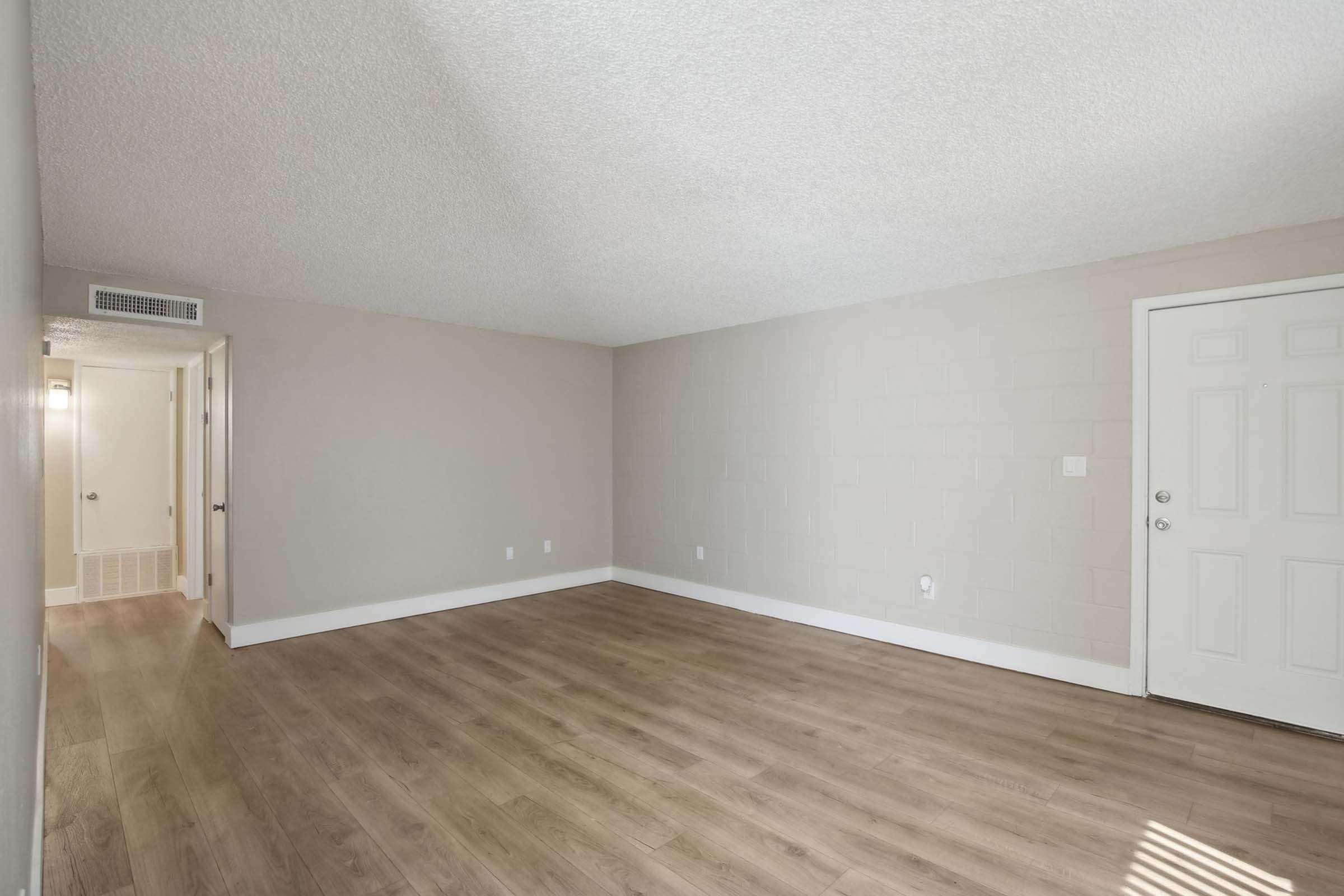 a large empty room with a wood floor