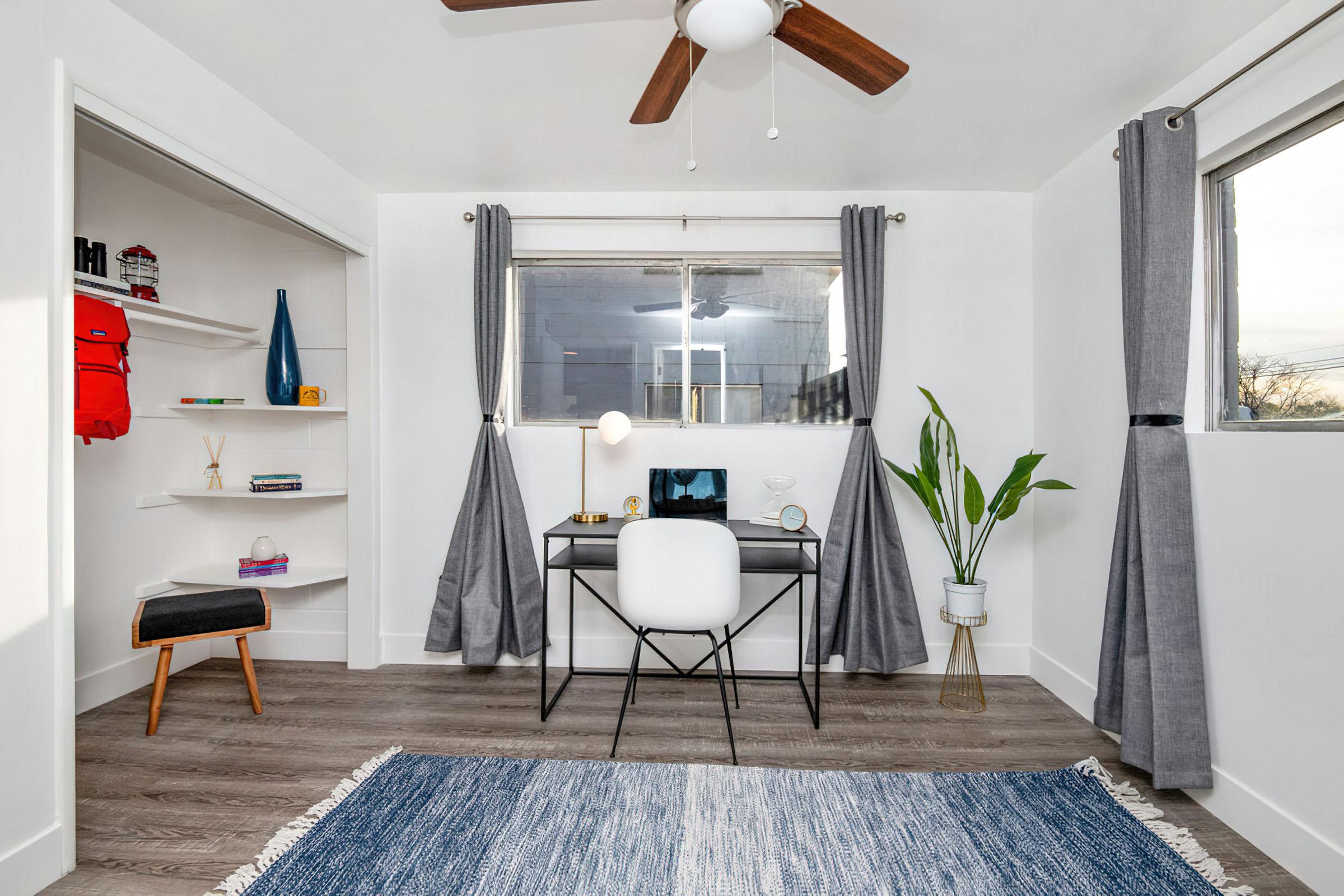 a living room filled with furniture and a large window