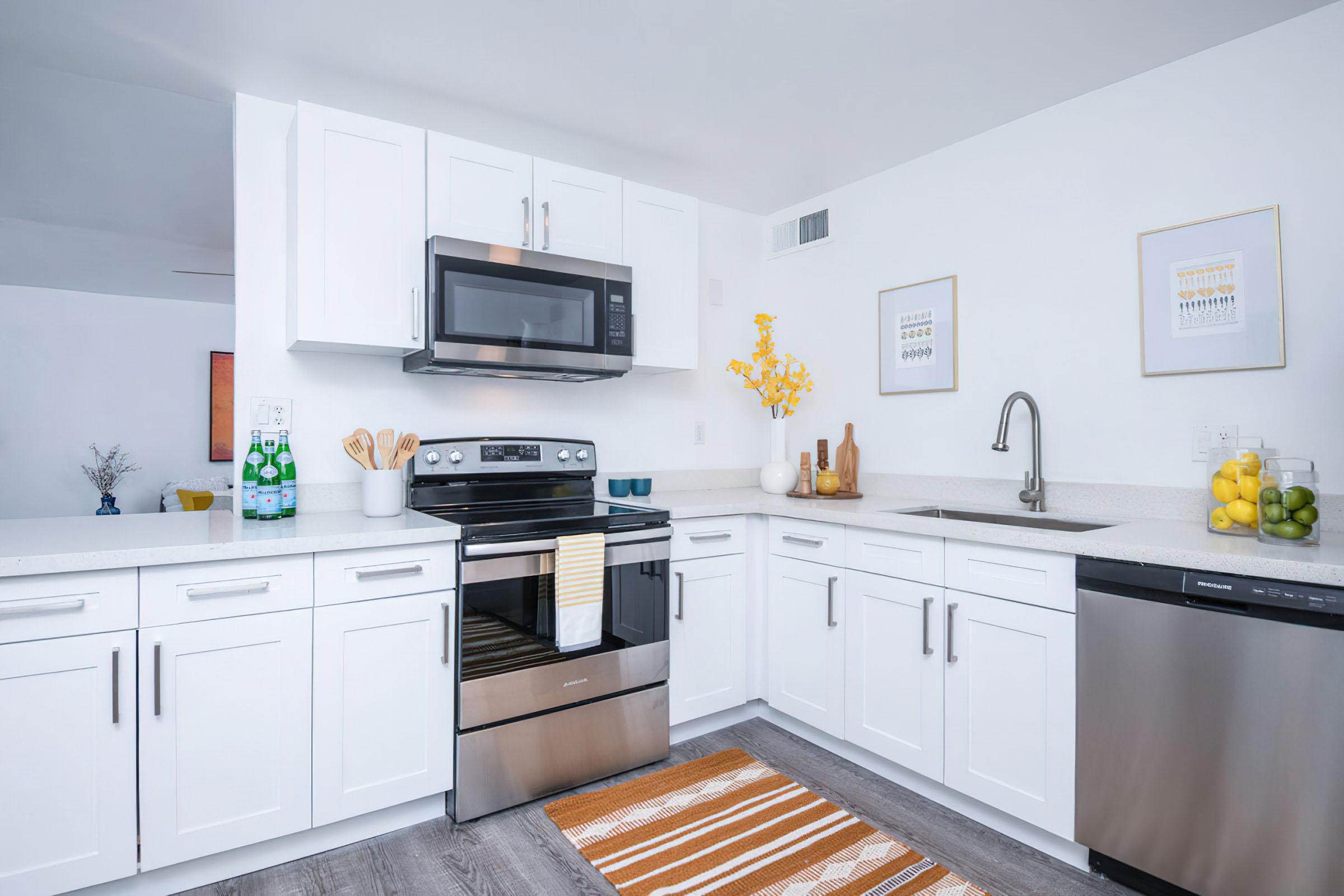 a kitchen with stainless steel appliances and wooden cabinets