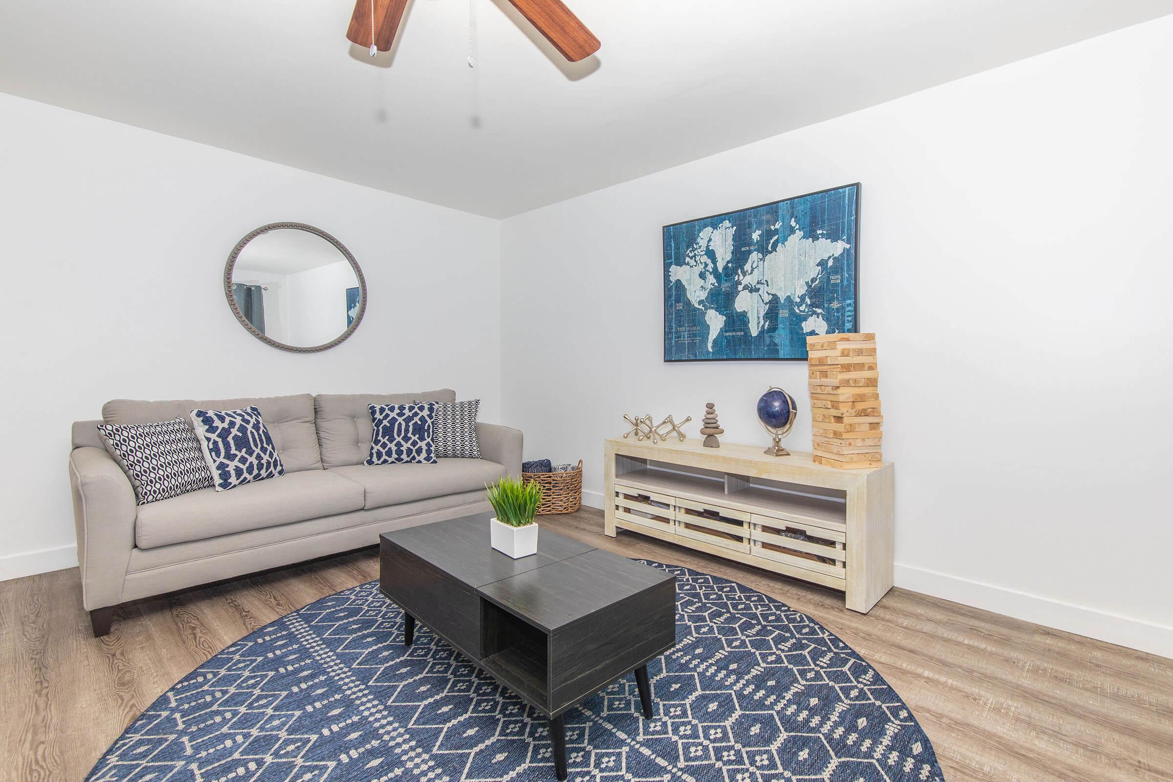 a living room filled with furniture and a rug