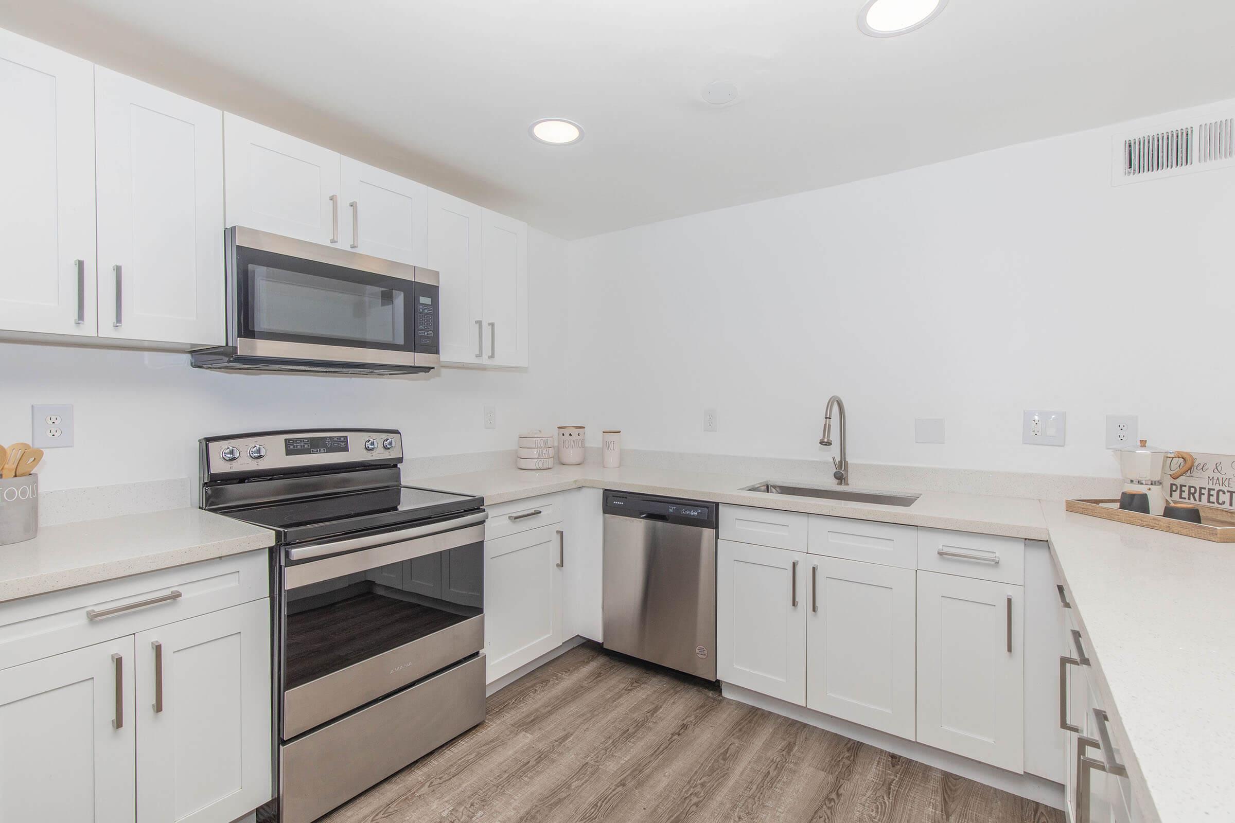 a stove top oven sitting inside of a kitchen