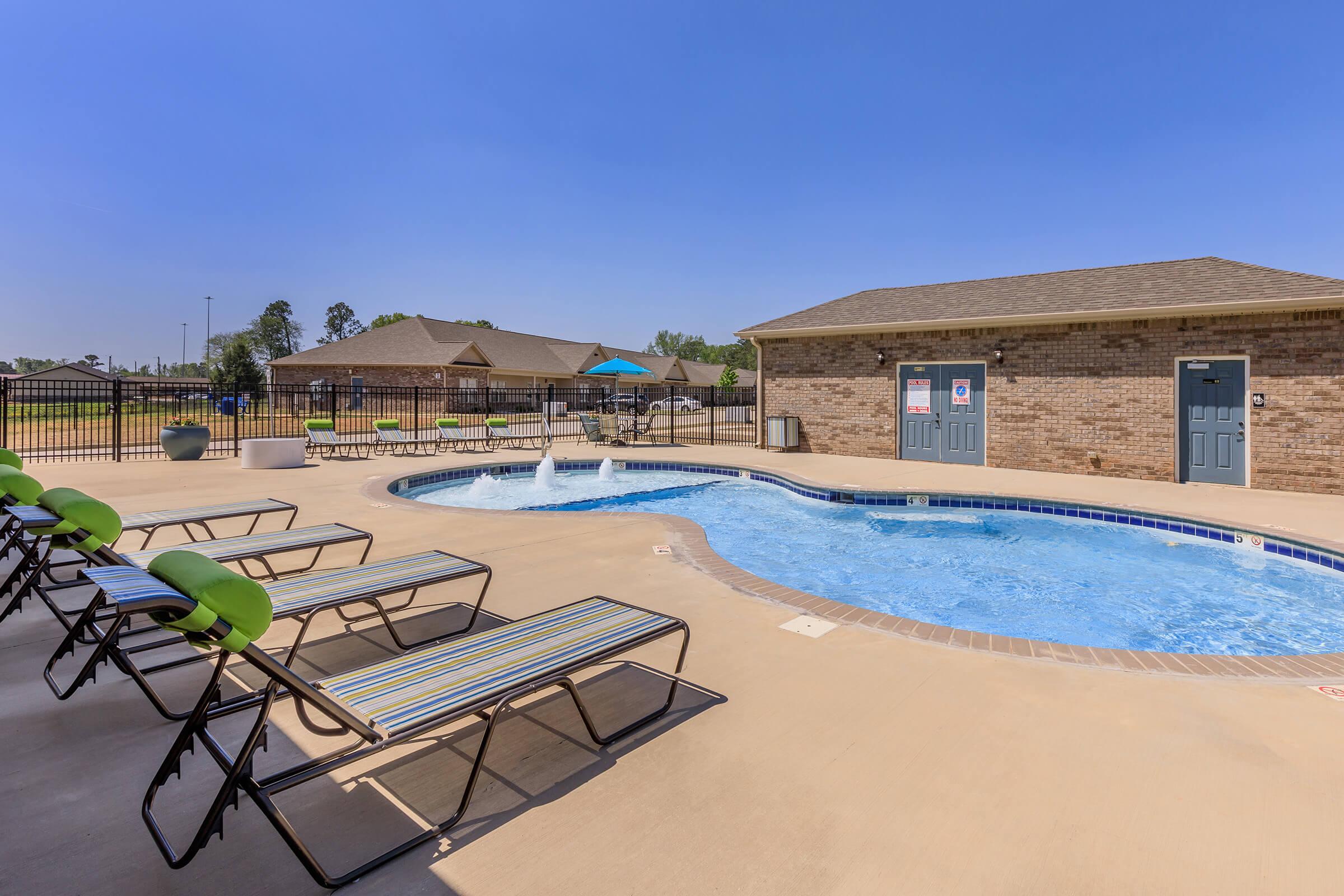 pool with deck chairs