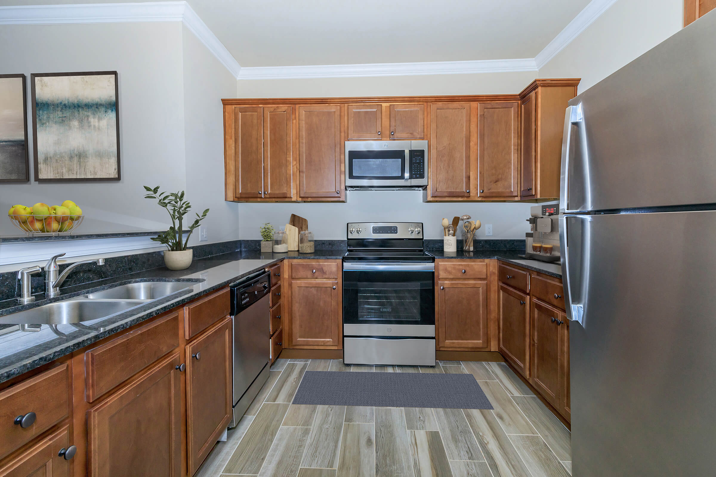 a large kitchen with stainless steel appliances and wooden cabinets