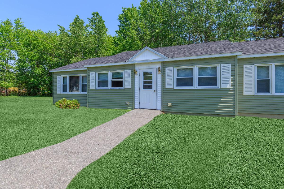 a green lawn in front of a house