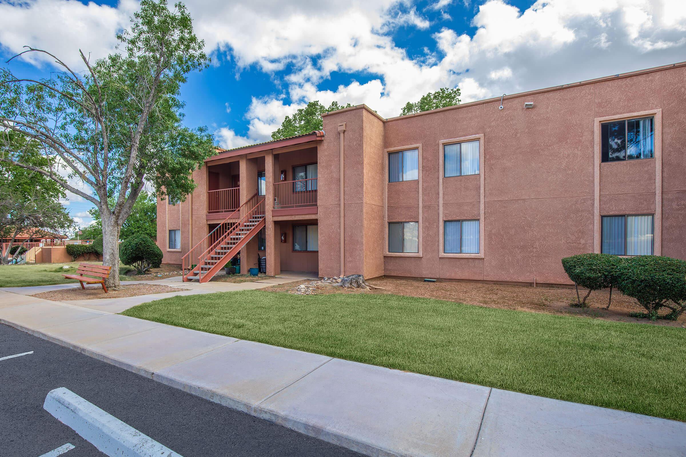 a tall brick building sitting on the side of a road