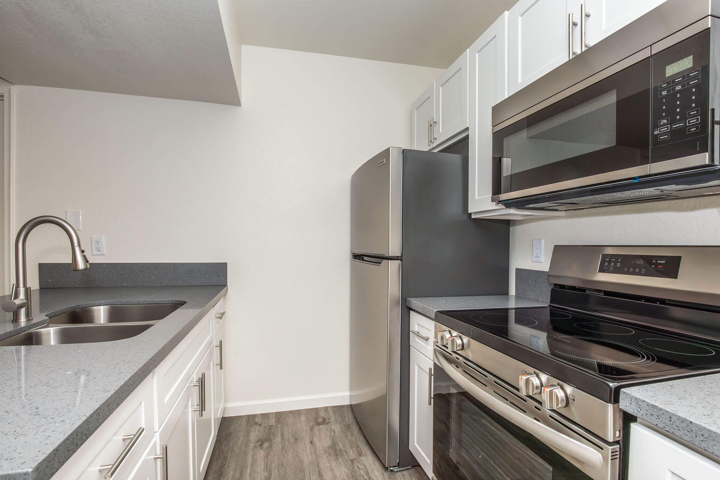 a stove top oven sitting inside of a kitchen