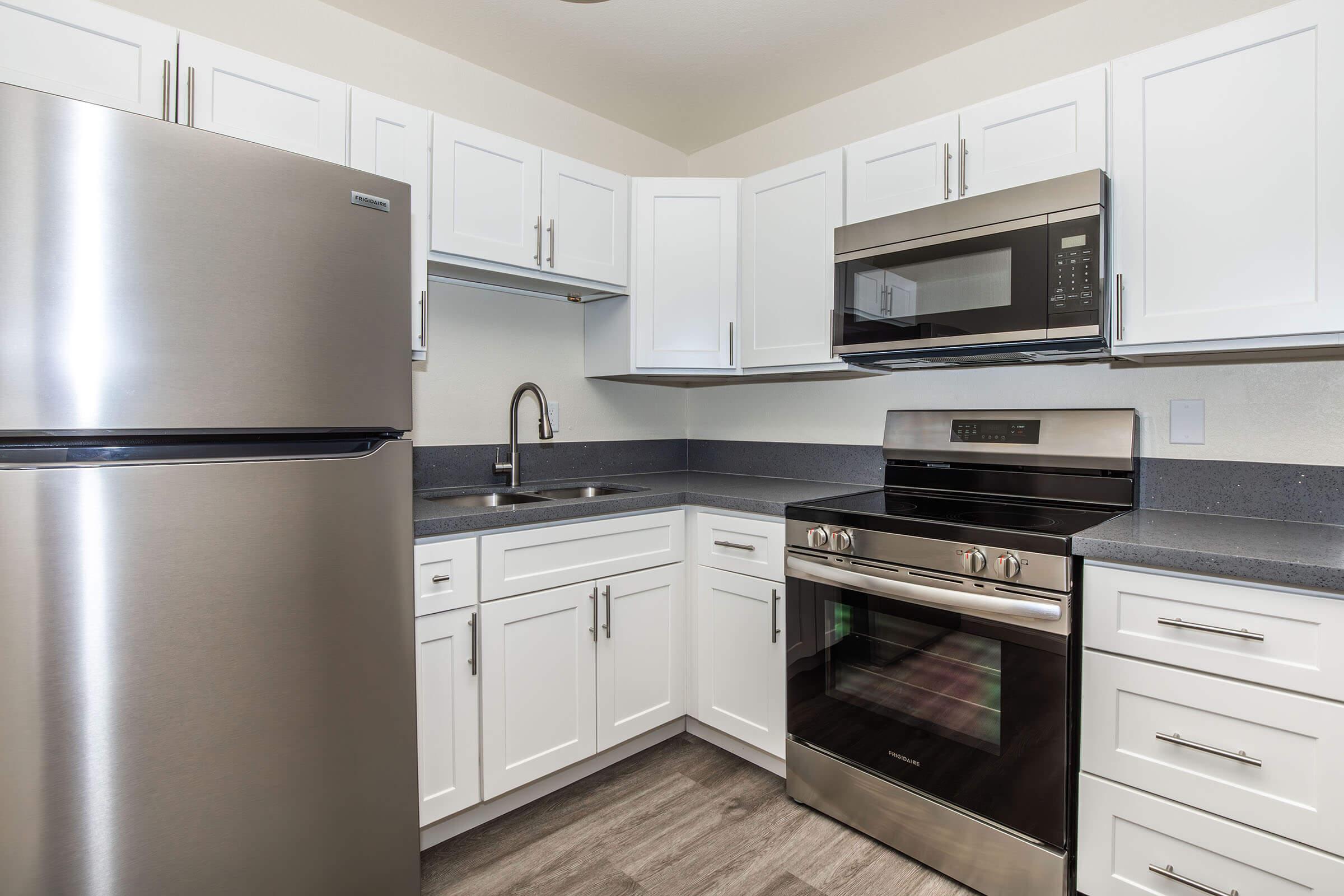 a kitchen with a stove and a refrigerator