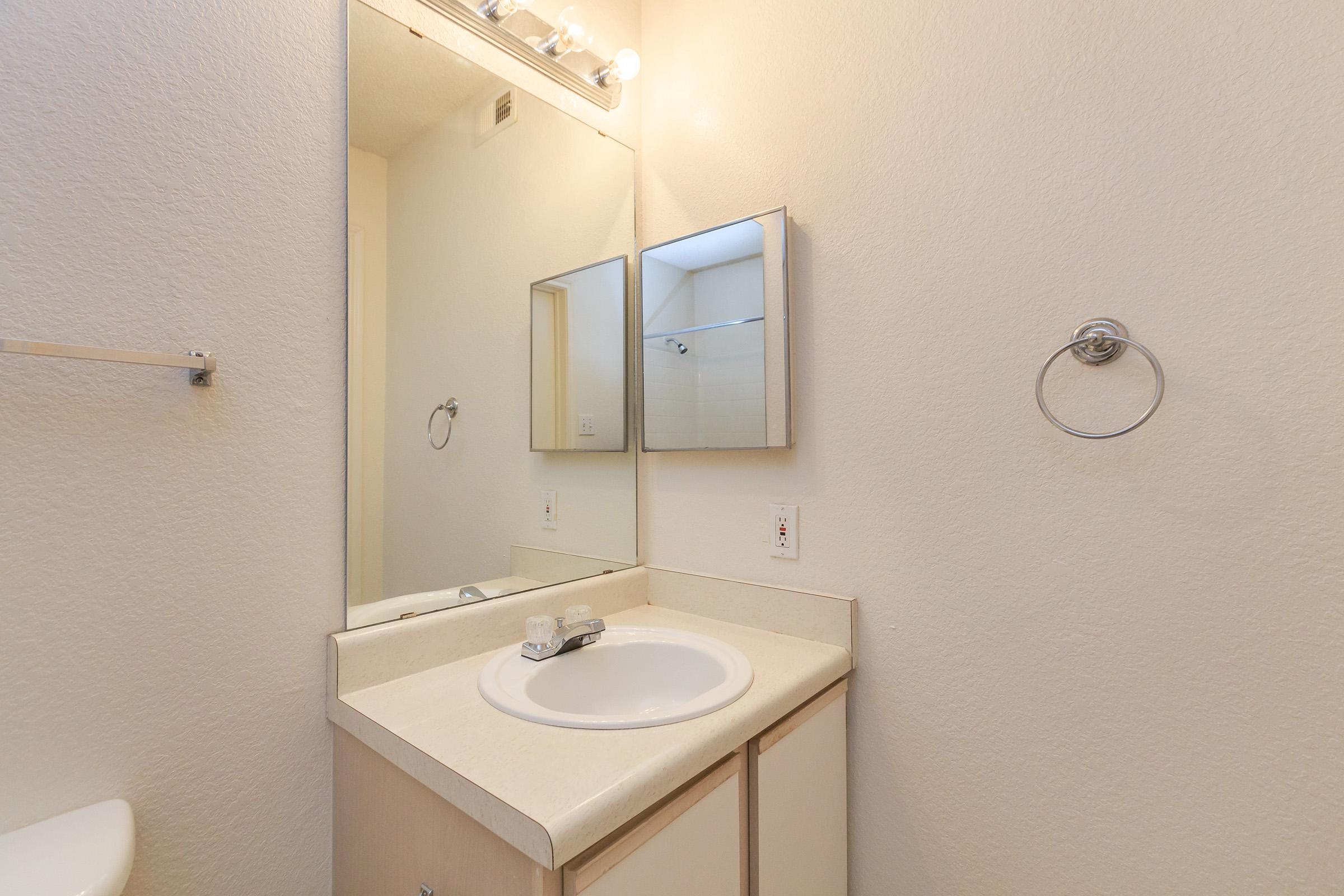 a white sink and a mirror