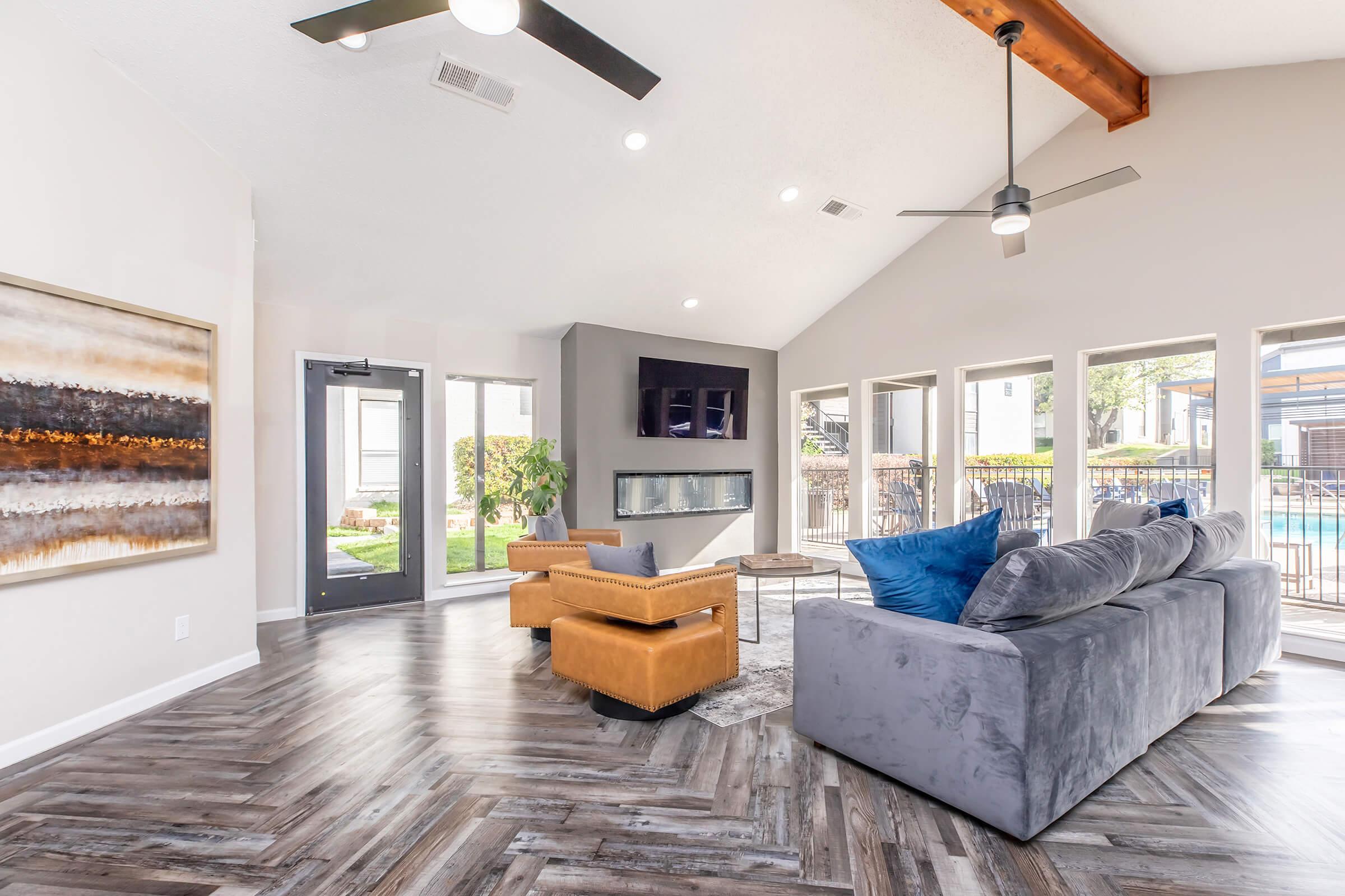 a living room filled with furniture and a large window