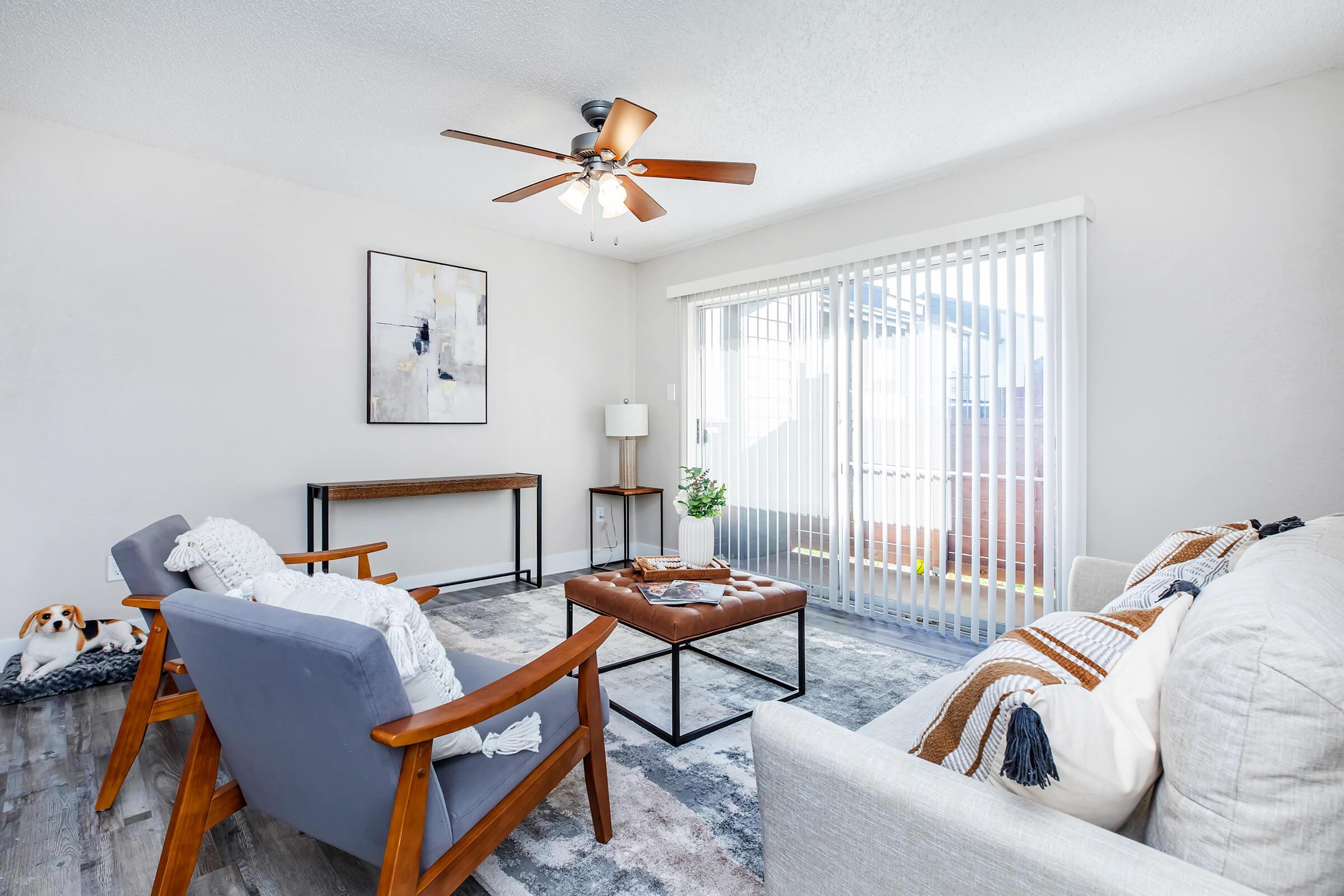 a bedroom with a bed and a chair in a room