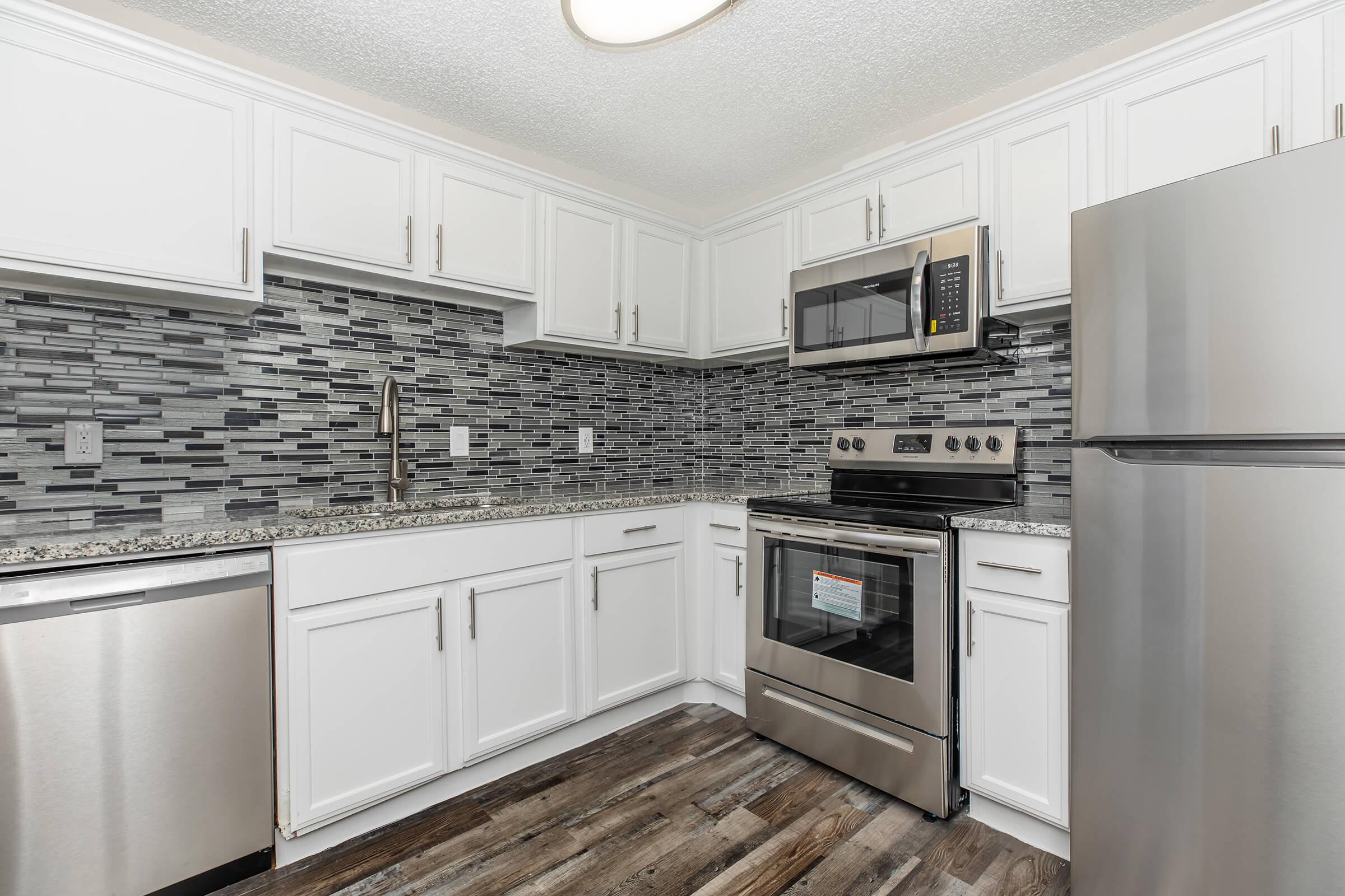 a kitchen with a stove and a refrigerator