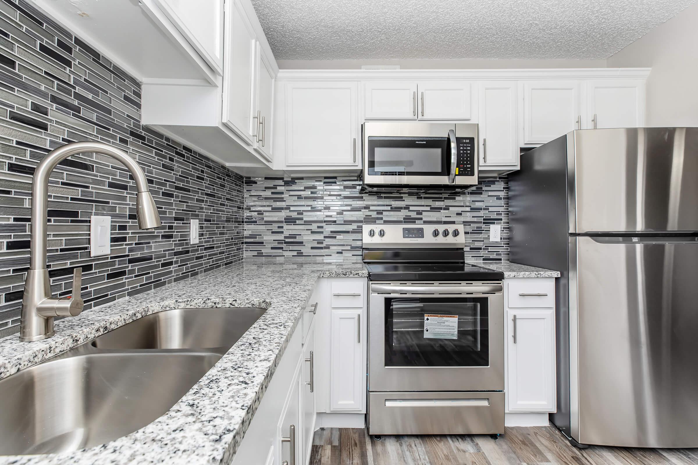 a modern kitchen with stainless steel appliances