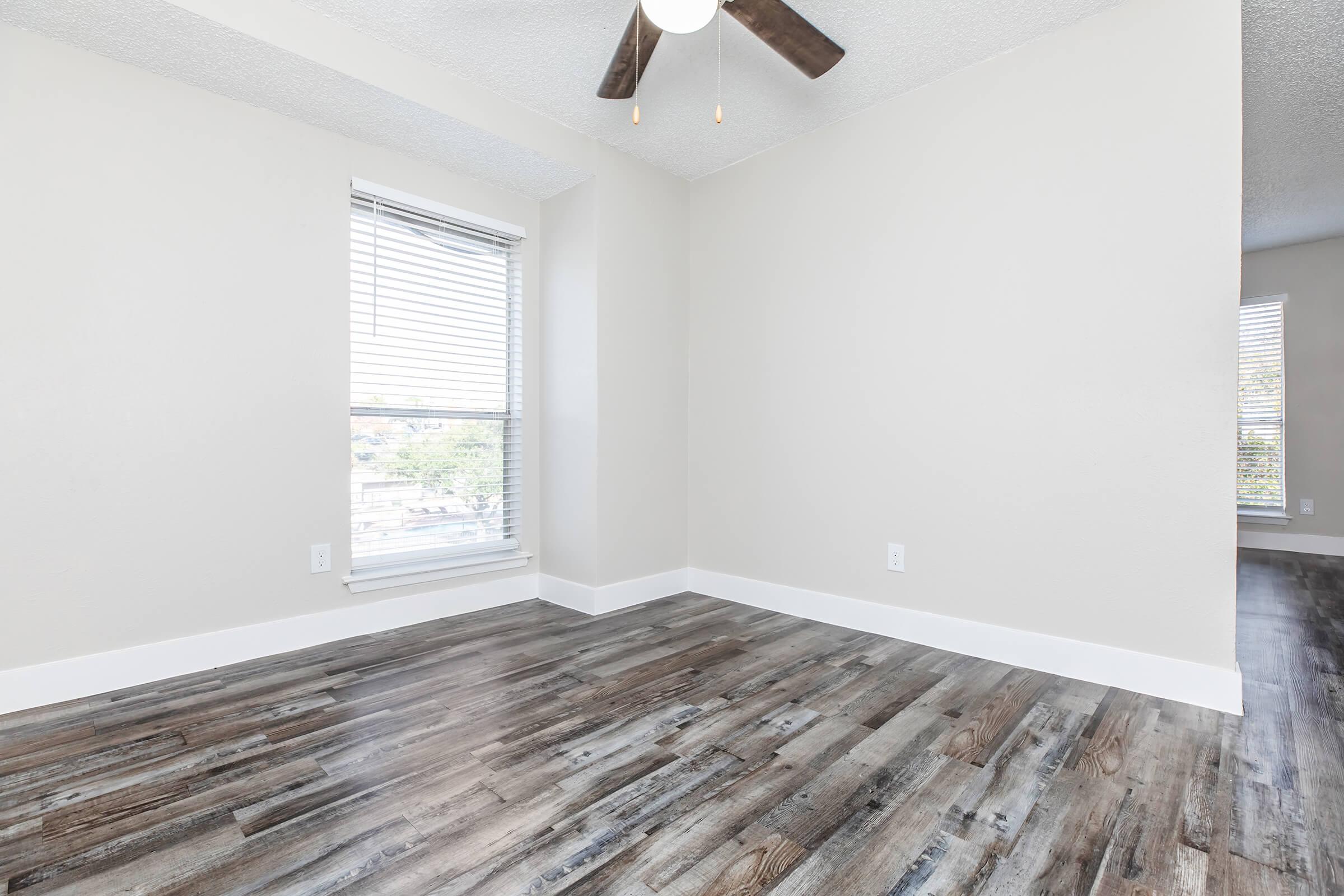 a bedroom with a wooden floor