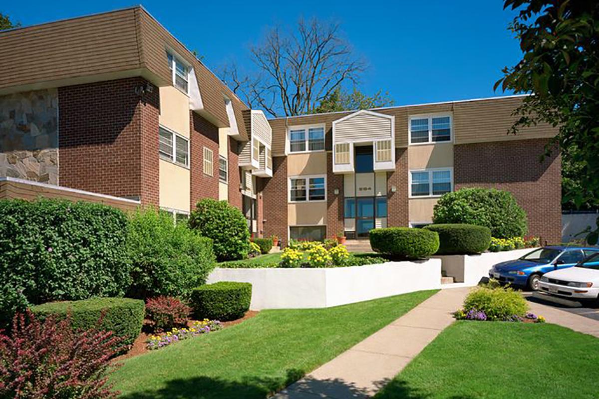 a large lawn in front of a brick building