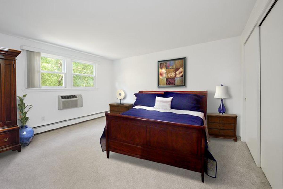 a living room filled with furniture and a large window