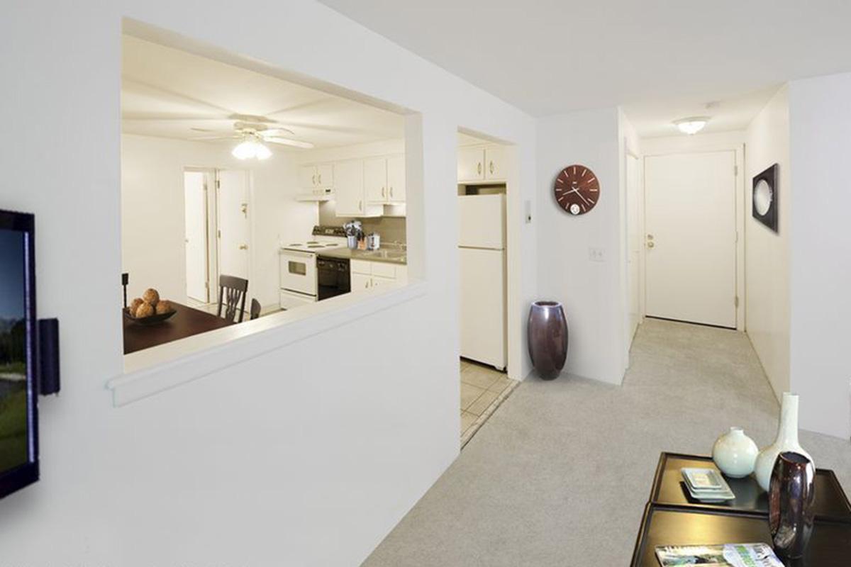 a kitchen with a refrigerator and table in a room