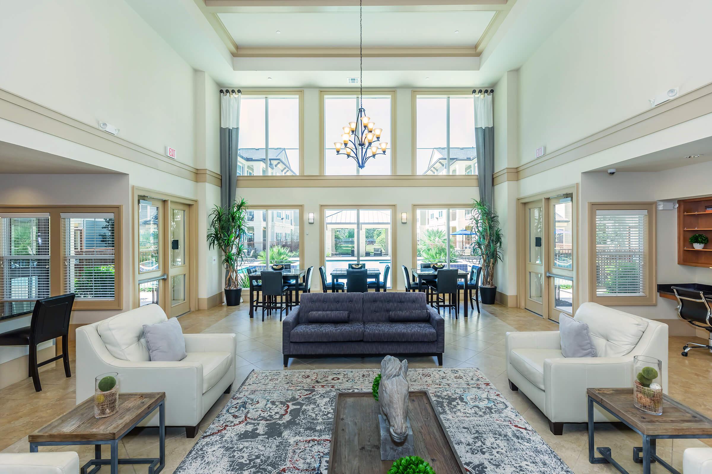 a living room filled with furniture and a large window