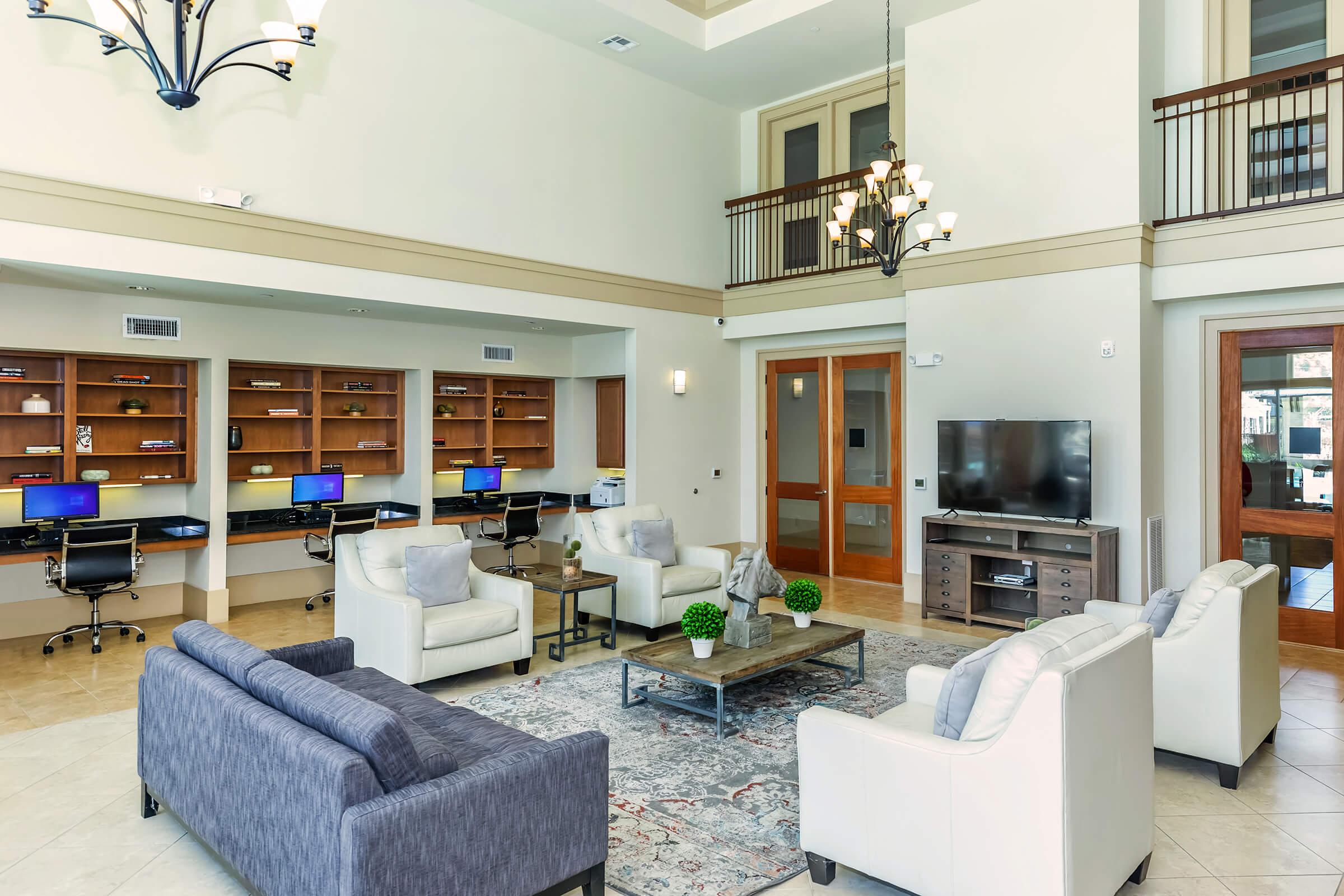 a living room filled with furniture and a large window