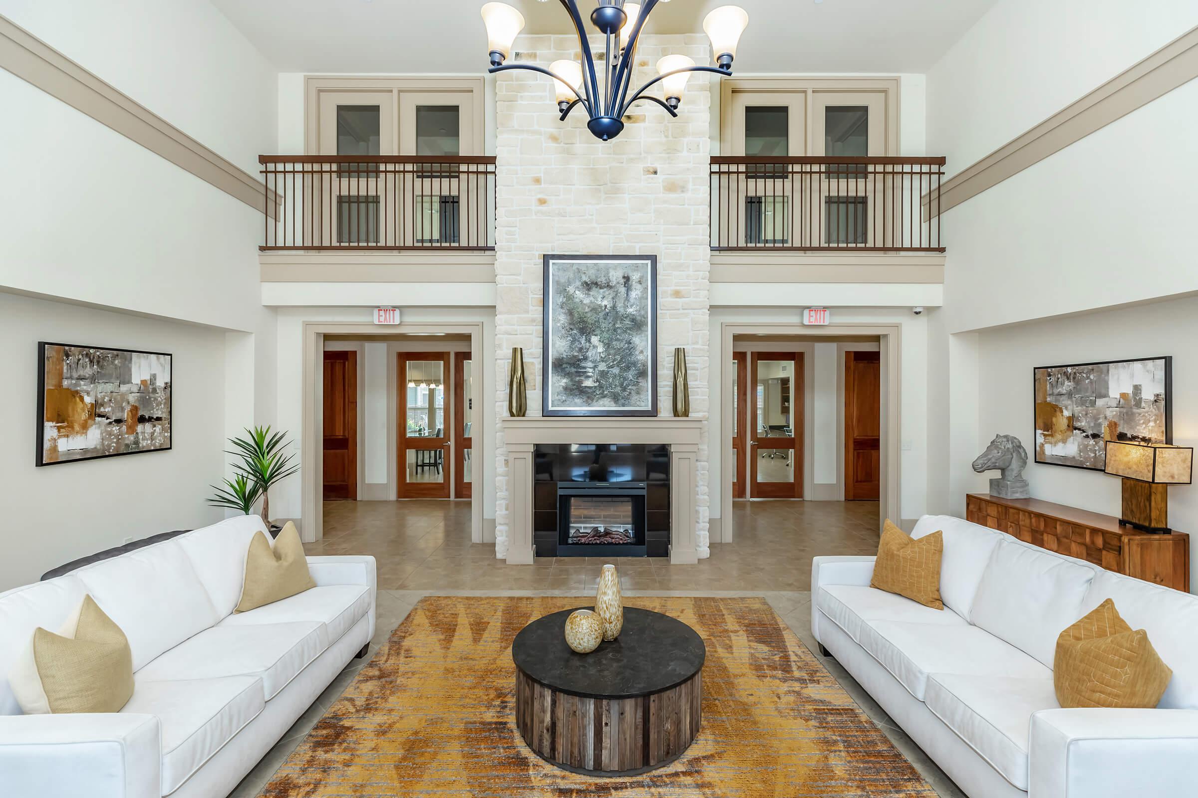 a living room filled with furniture and a fire place