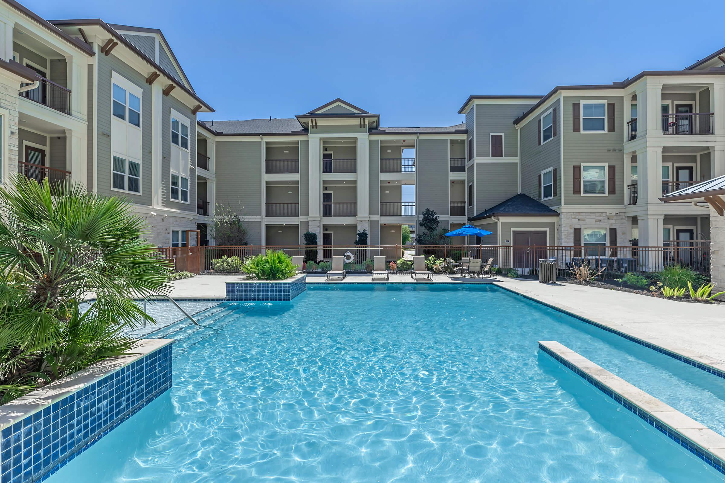 a blue pool of water in front of a building