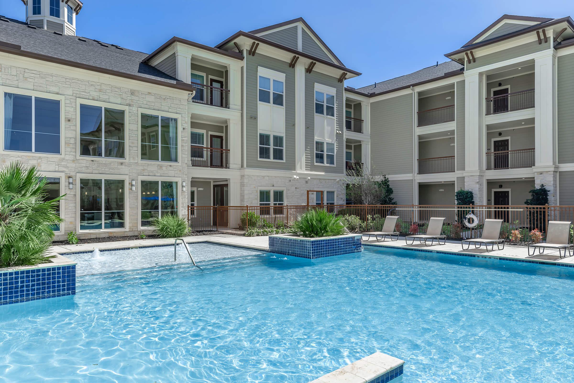 a blue pool of water in front of a building