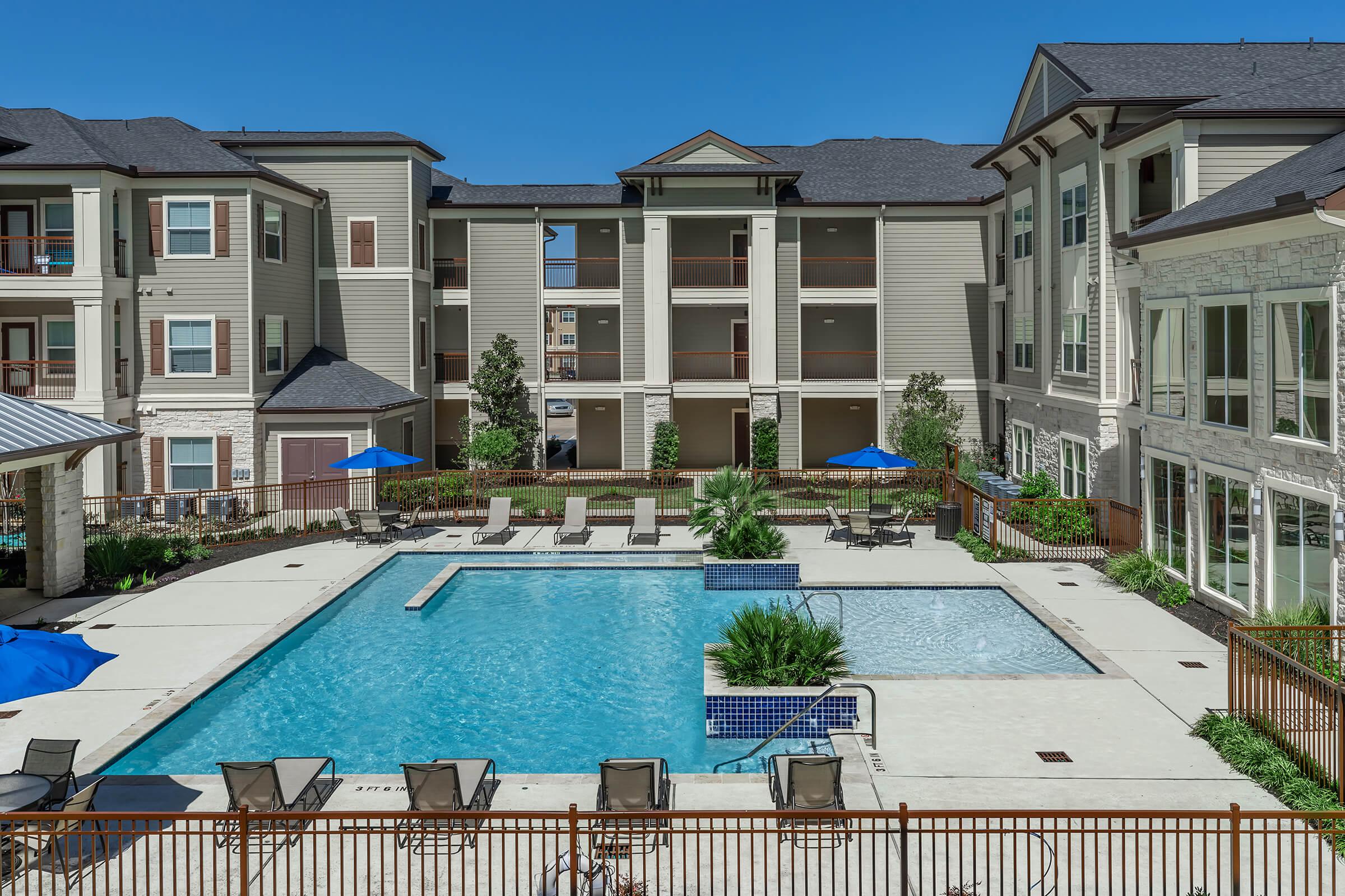 a house with a pool in front of a building