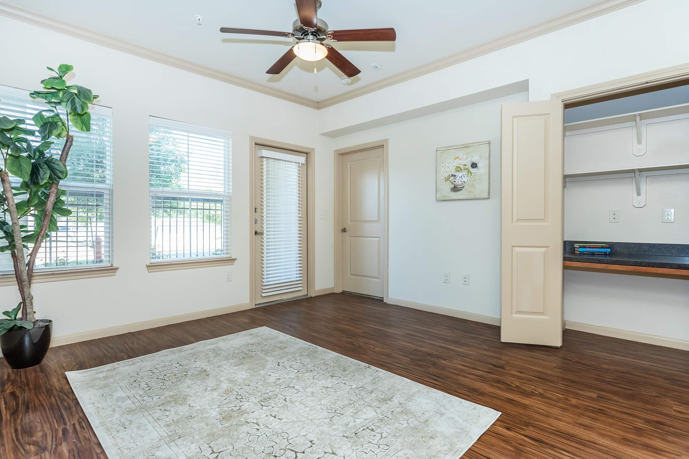 a living room filled with furniture and a large window