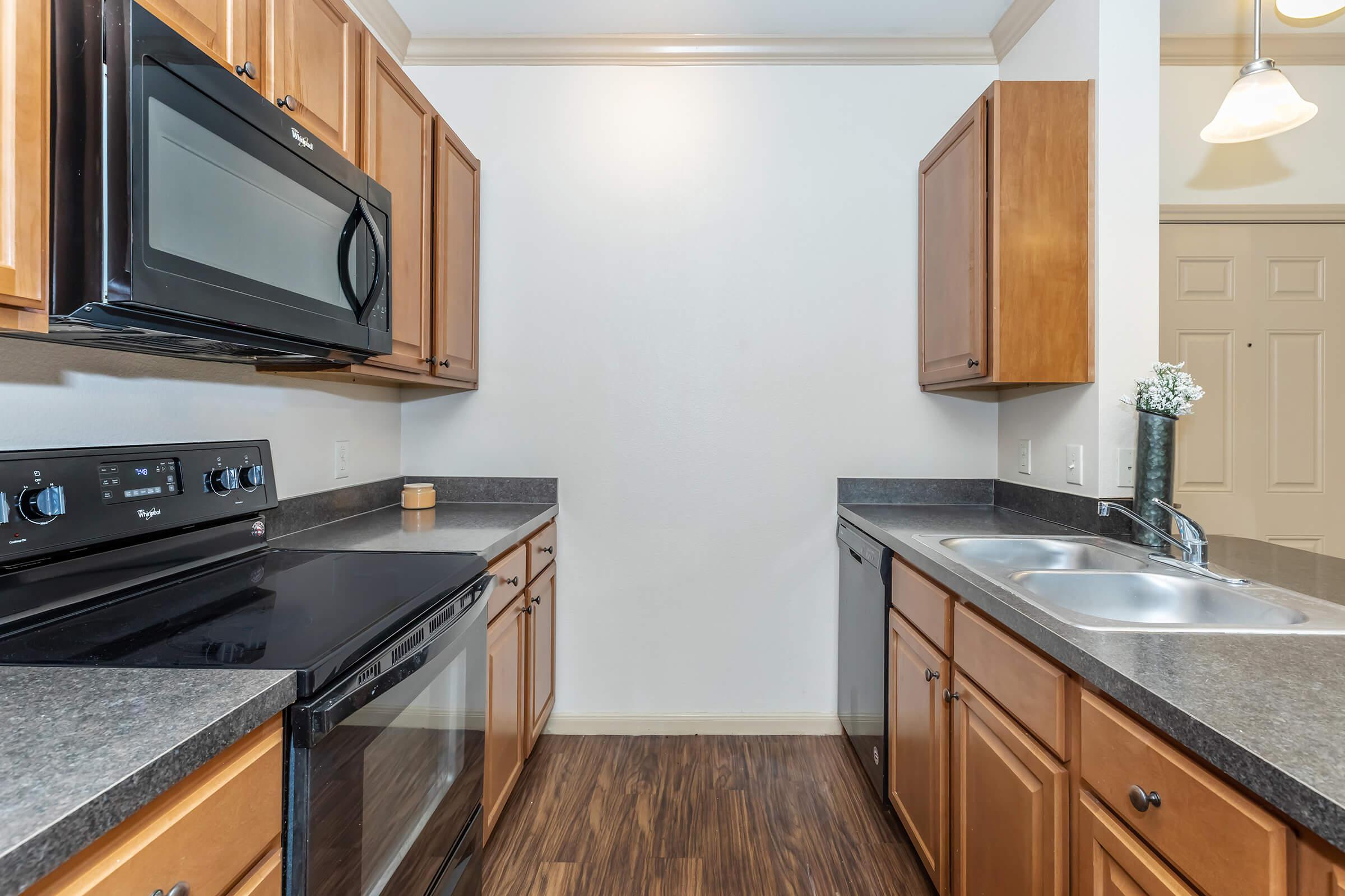 a modern kitchen with stainless steel appliances and wooden cabinets