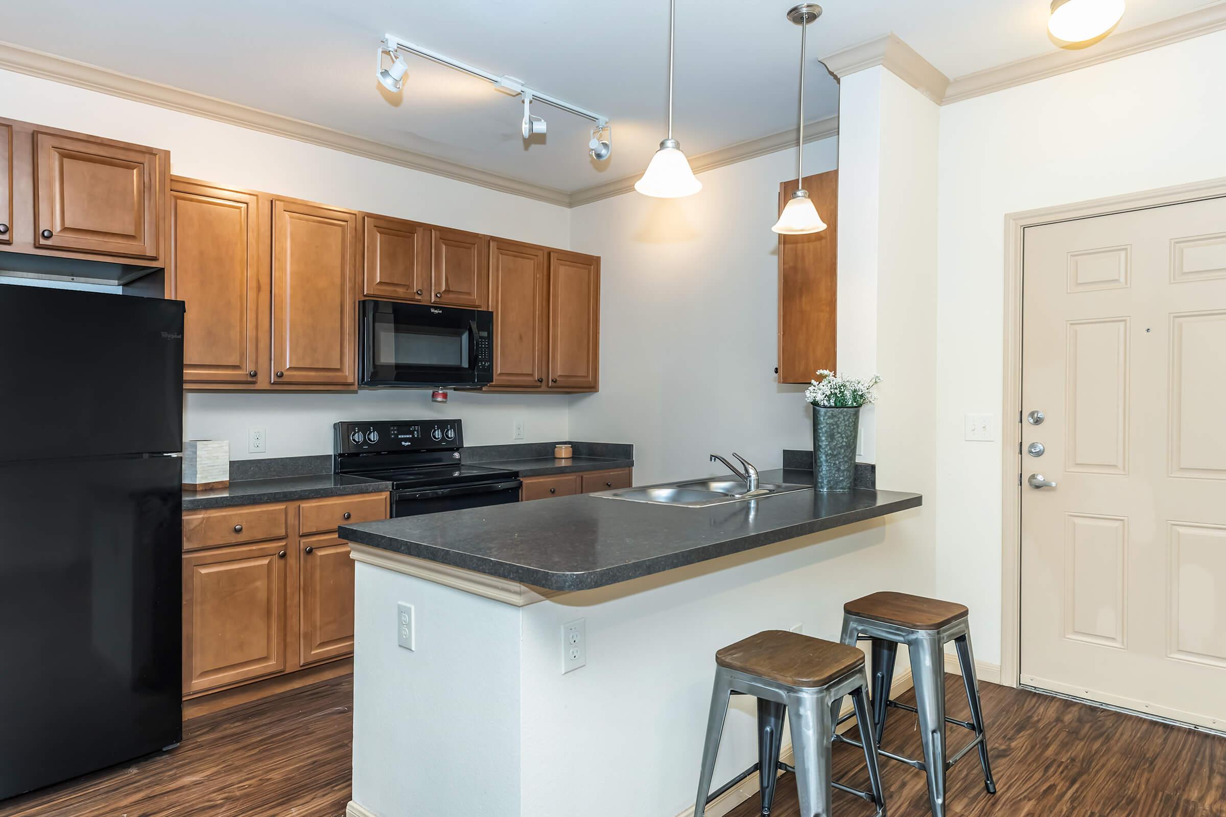 a kitchen with an island in the middle of a room