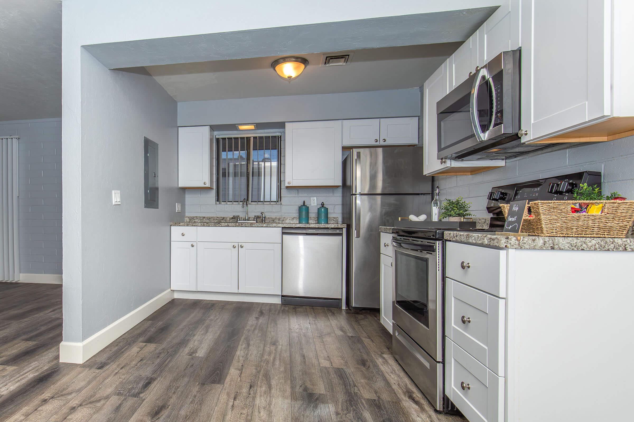 a kitchen area with a building in the background