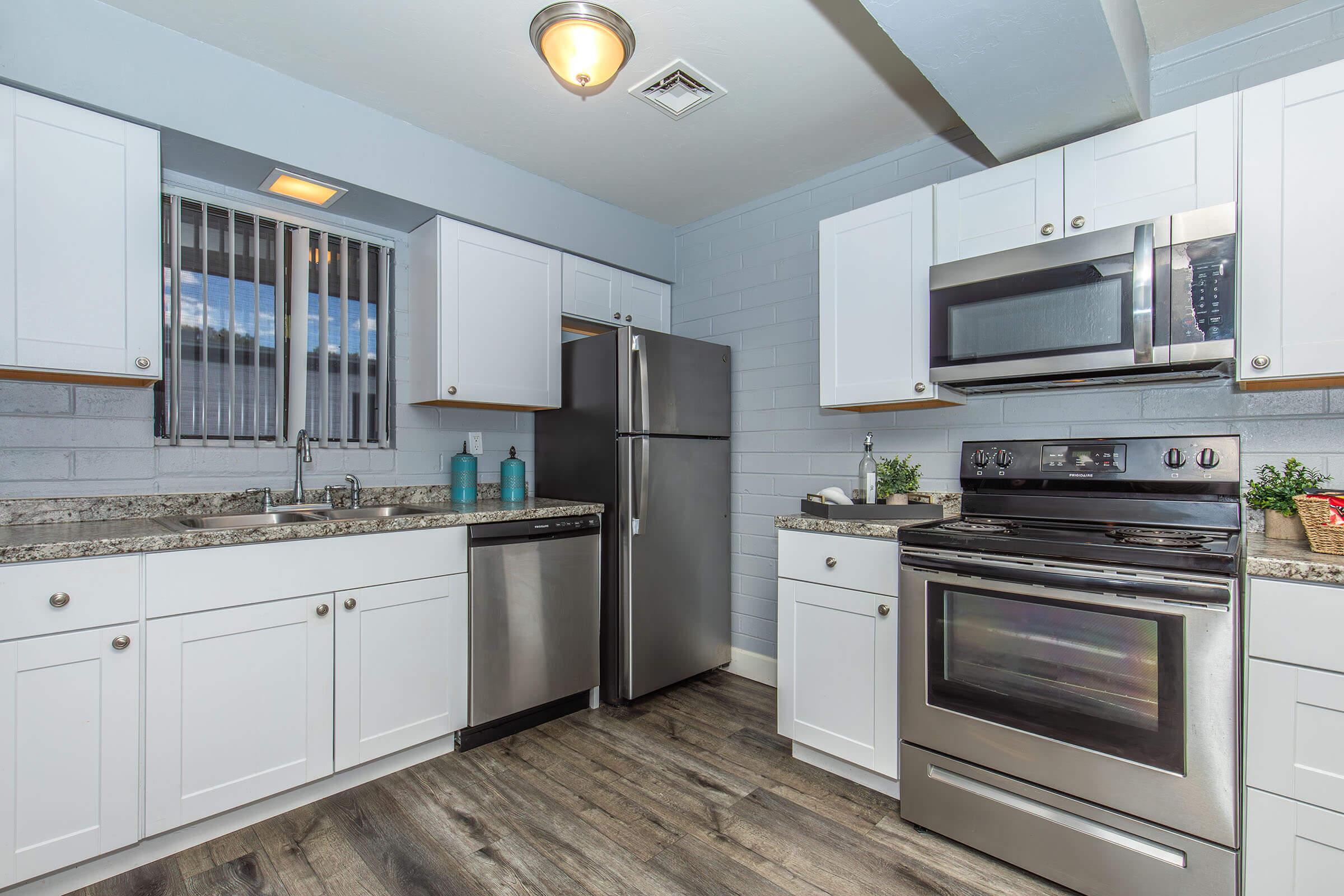 a kitchen with a stove top oven sitting inside of a room