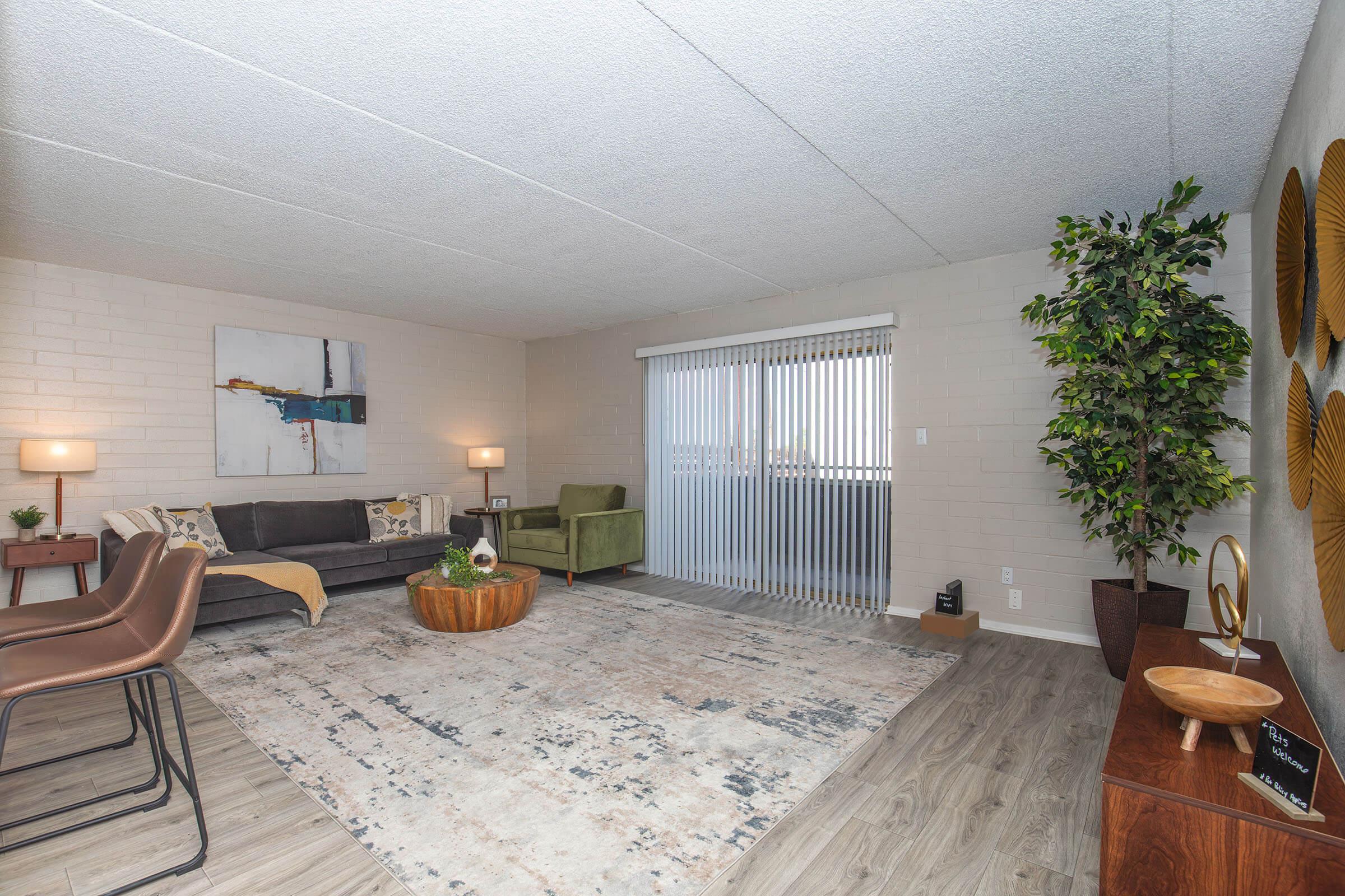 a living room filled with furniture and a large window