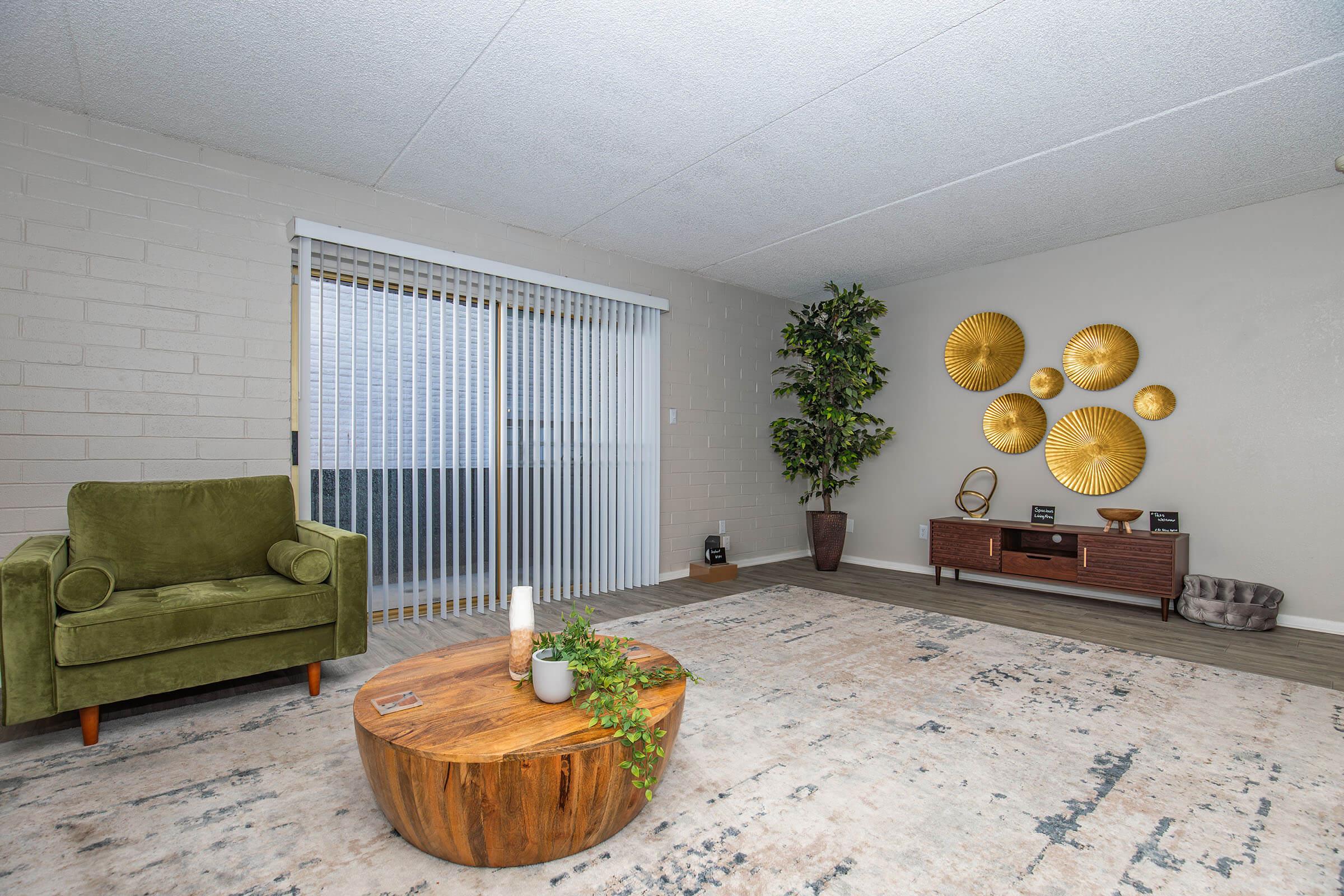 a living room filled with furniture and vase of flowers on a table