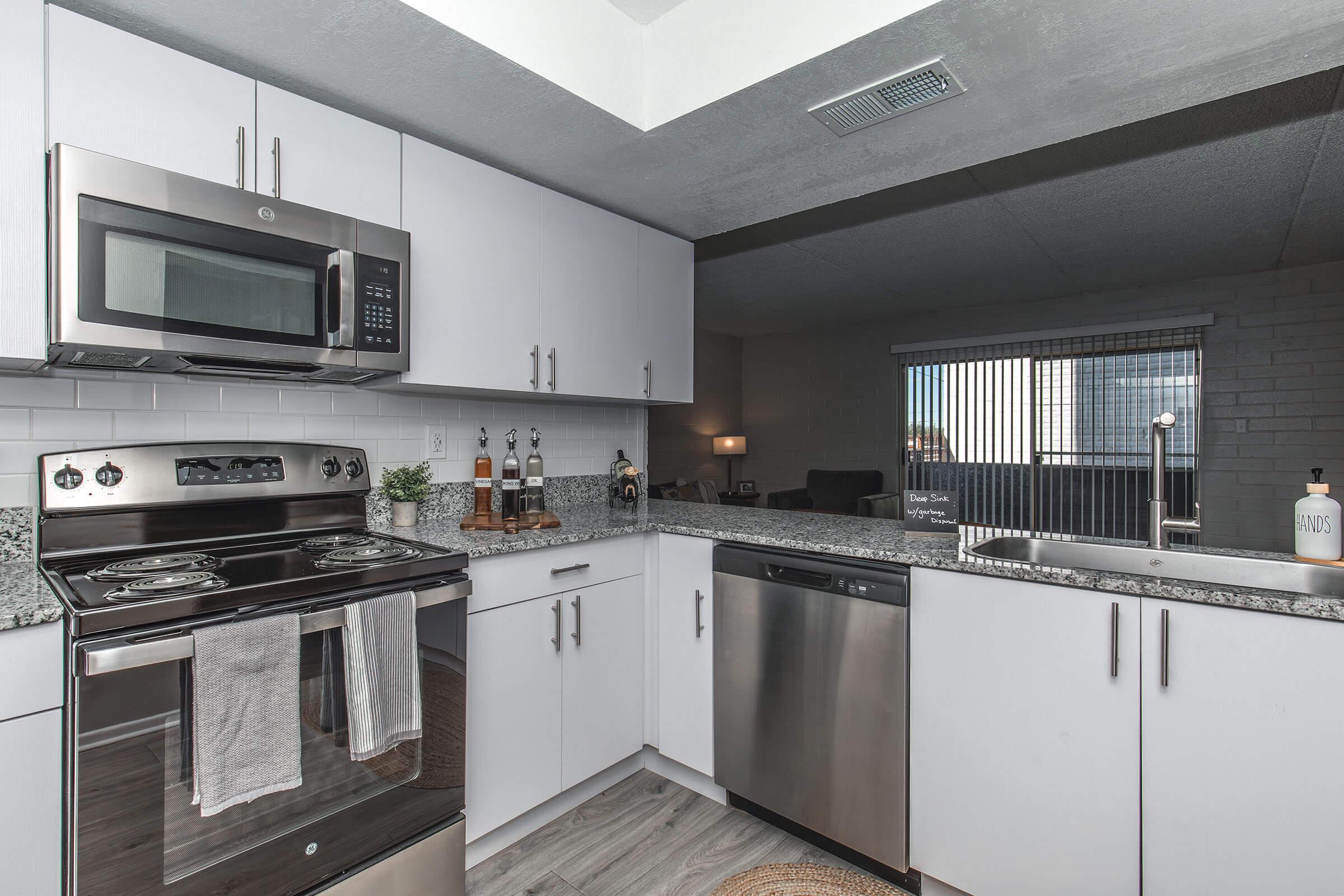 a stove top oven sitting inside of a kitchen