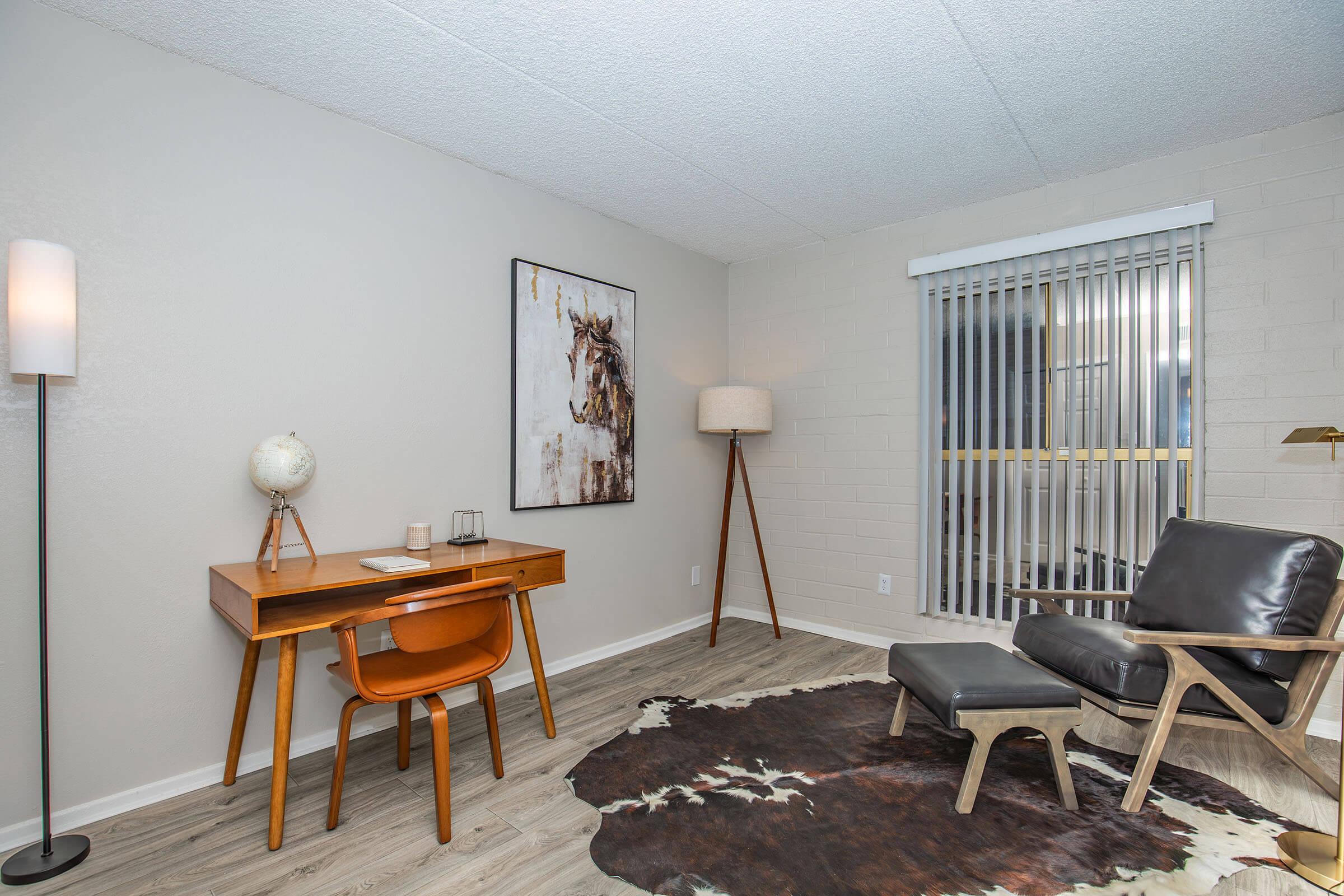 a living room filled with furniture and a lamp