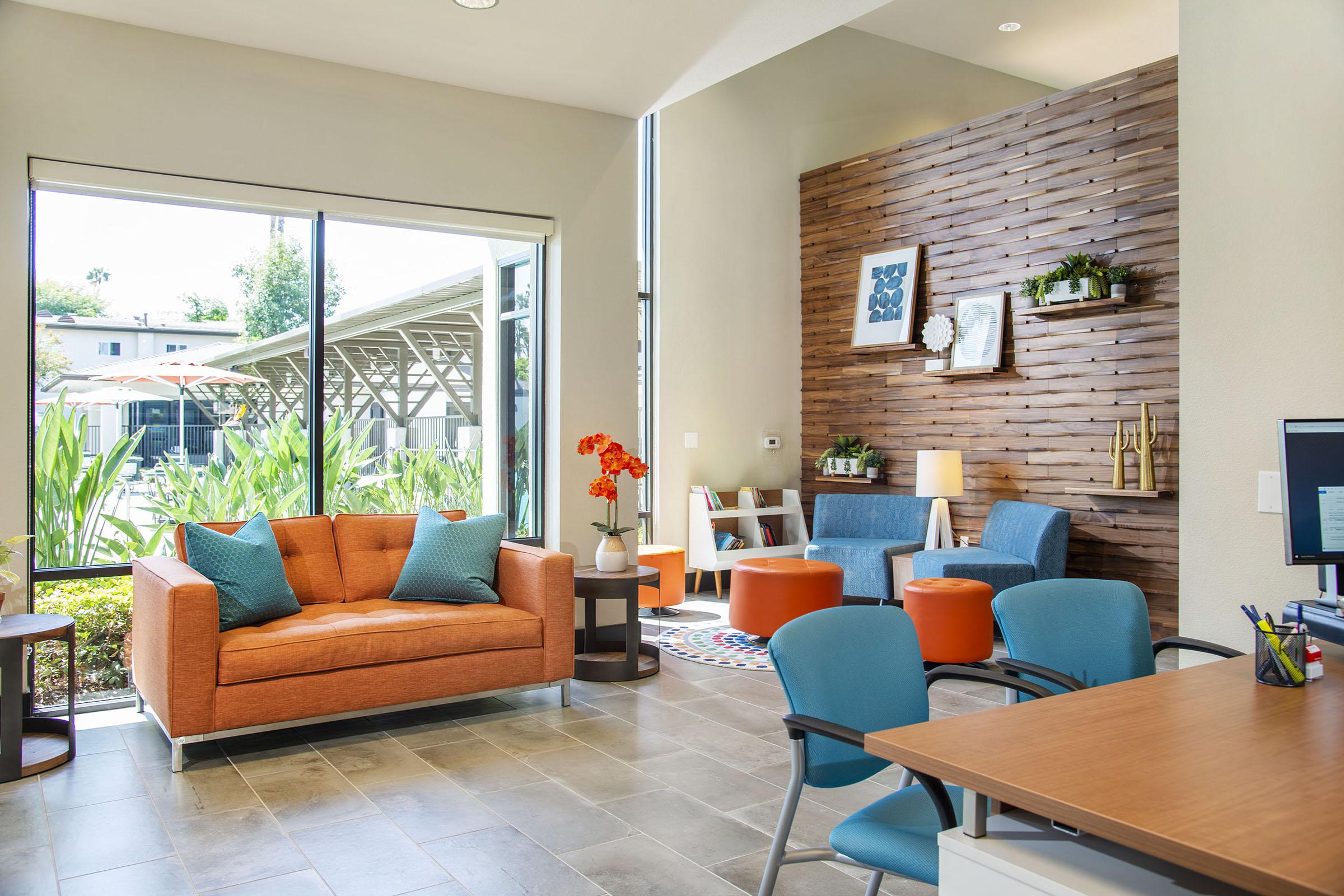 a living room filled with furniture and a large window