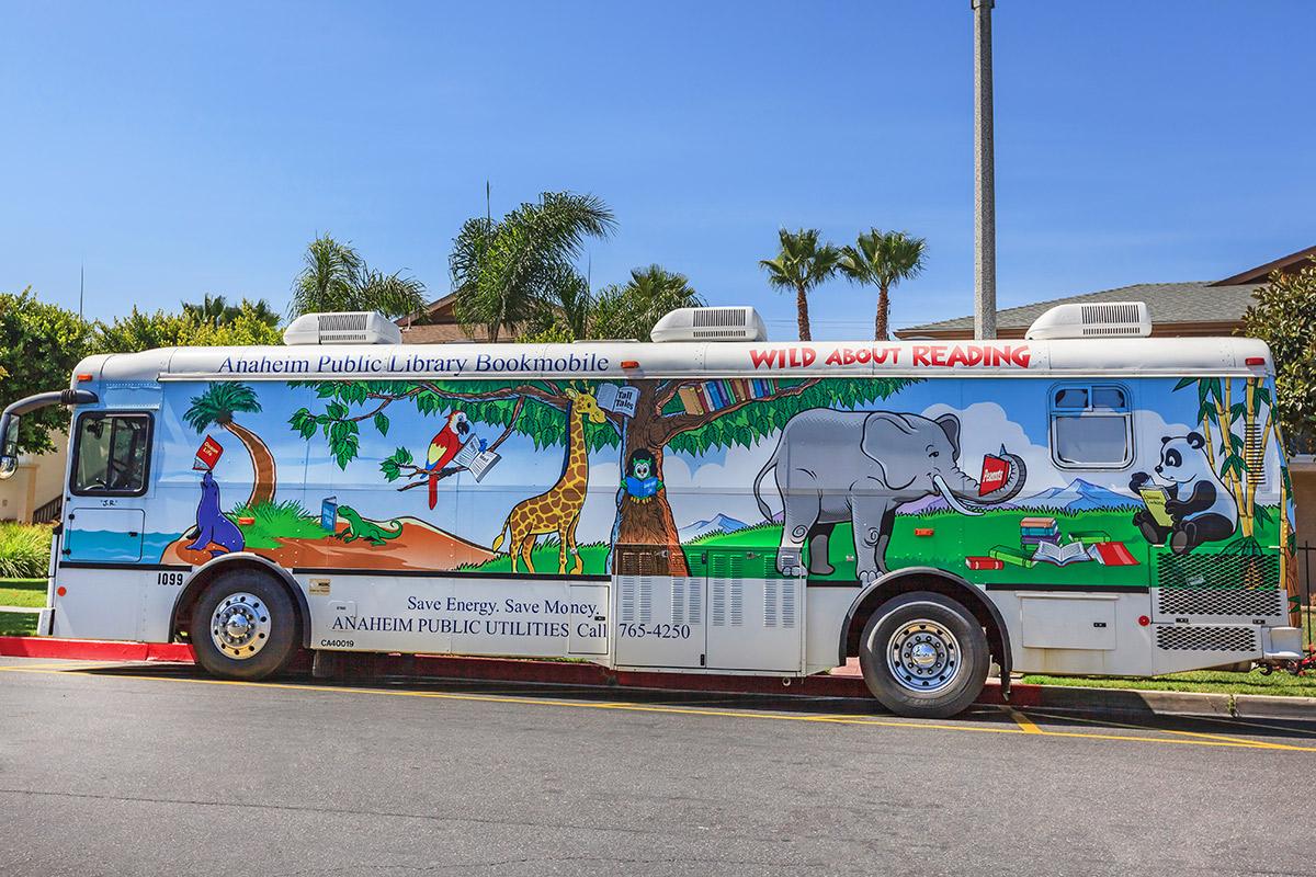 a colorful bus parked in front of a truck