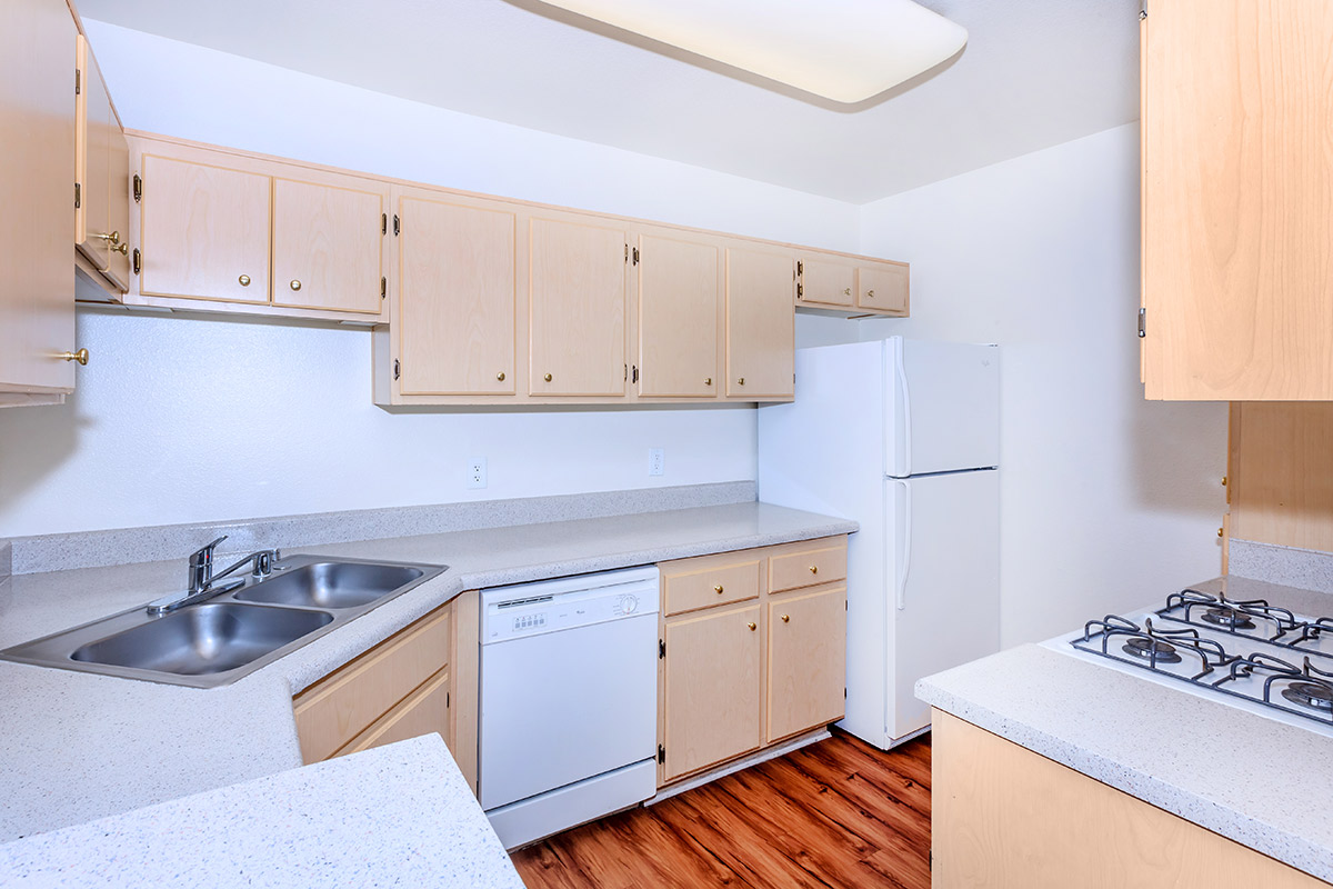 a kitchen with a stove a sink and a microwave