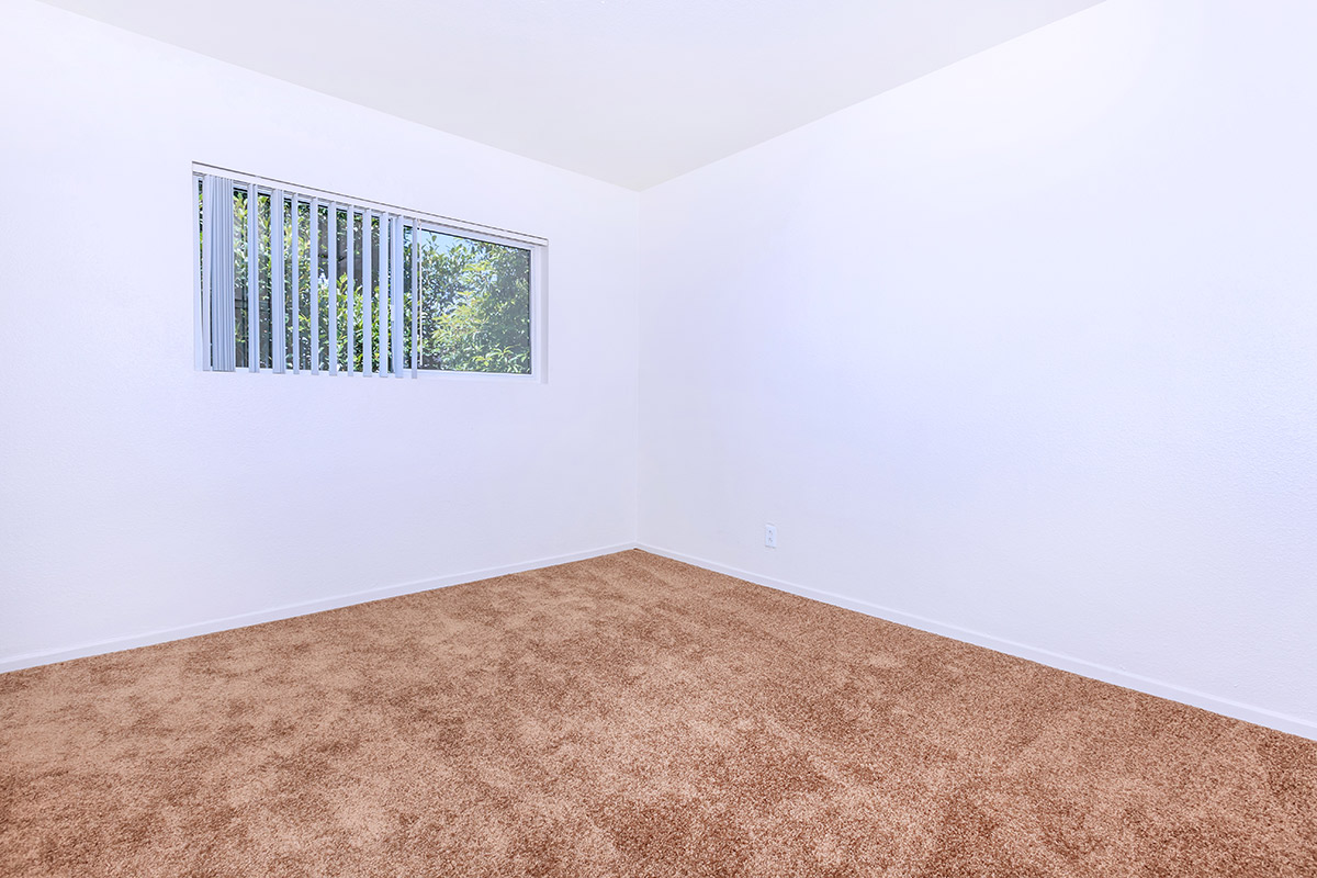 a bedroom with a bed in a room
