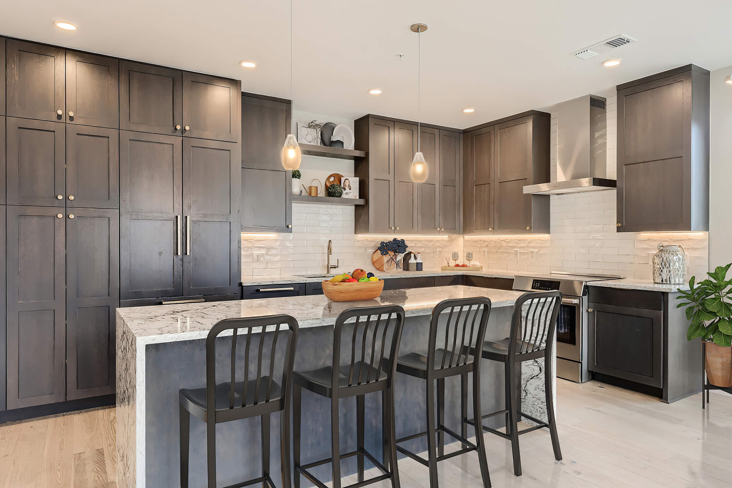 a kitchen with a table and chairs in a room