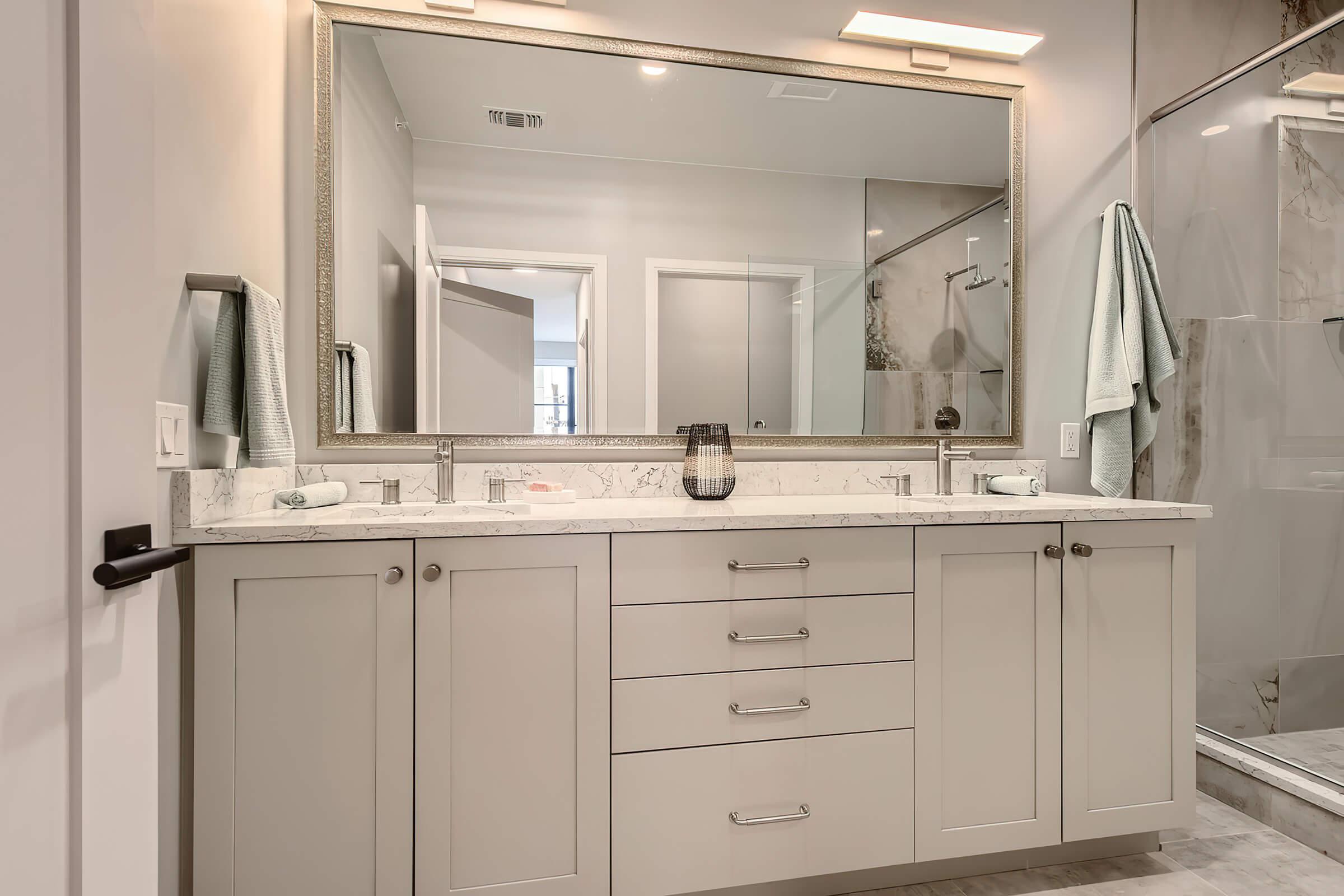 a kitchen with a sink and a mirror