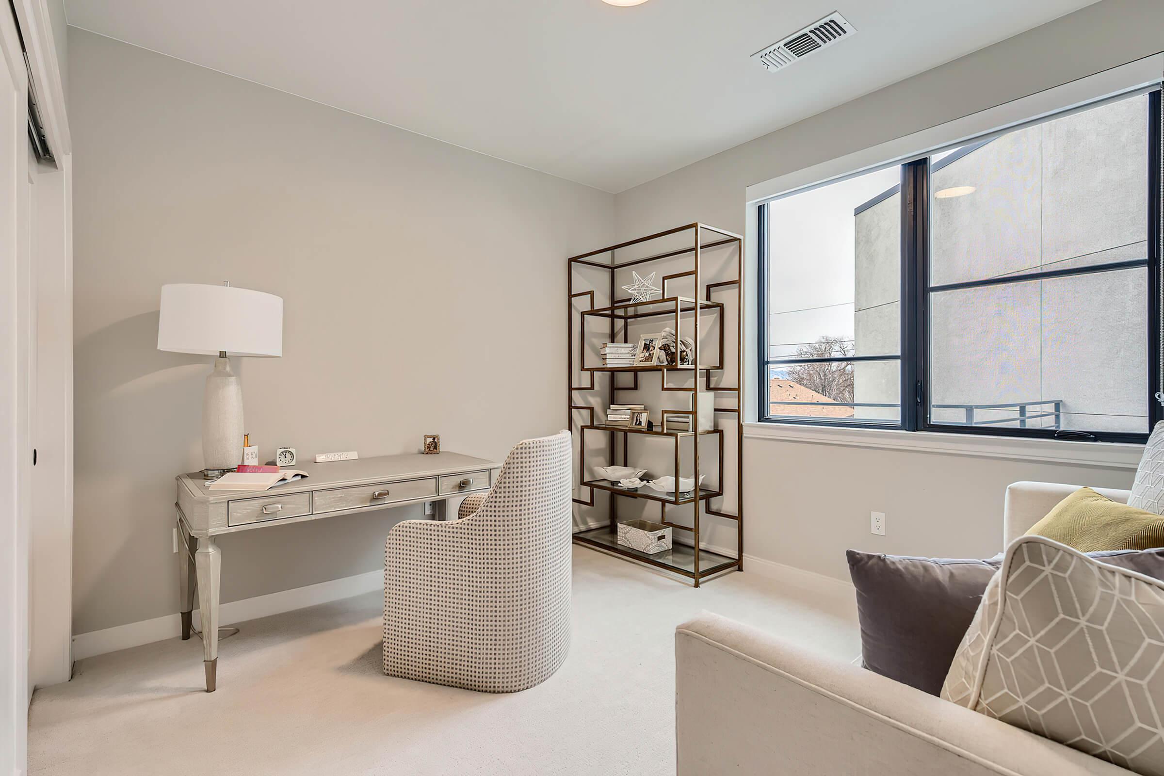 a living room filled with furniture and a large window