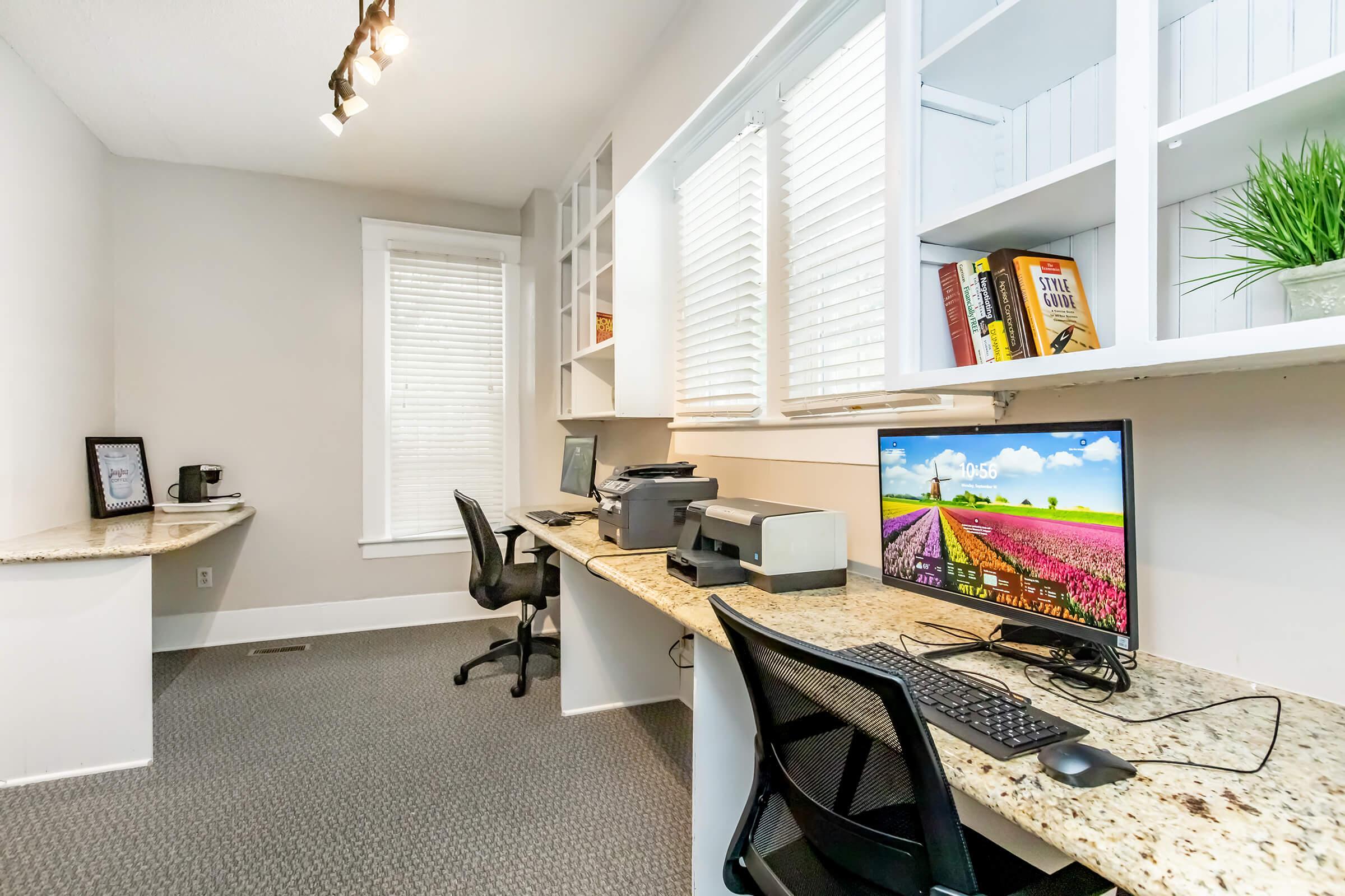 a desk with a computer in a room