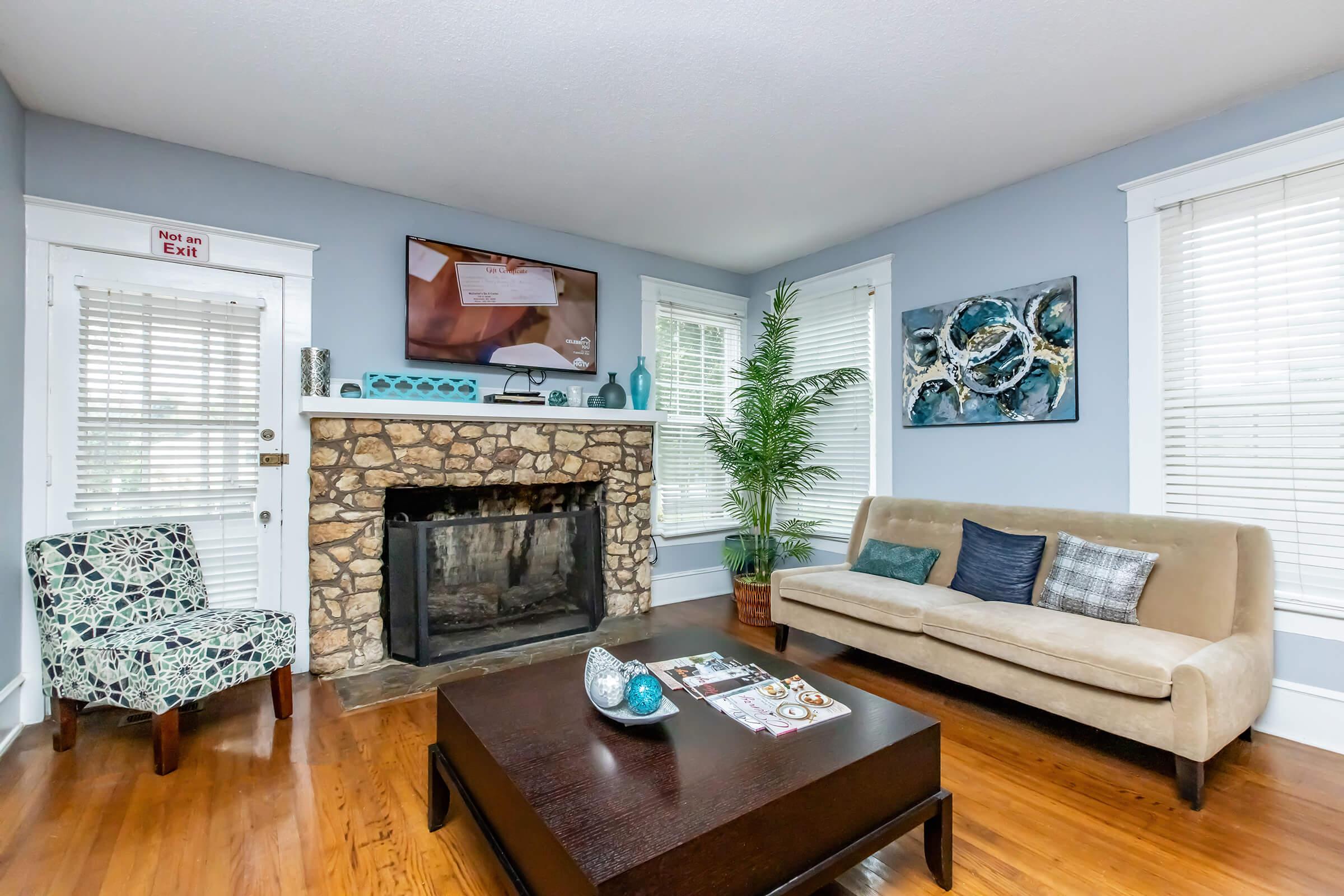 a living room filled with furniture and a fire place