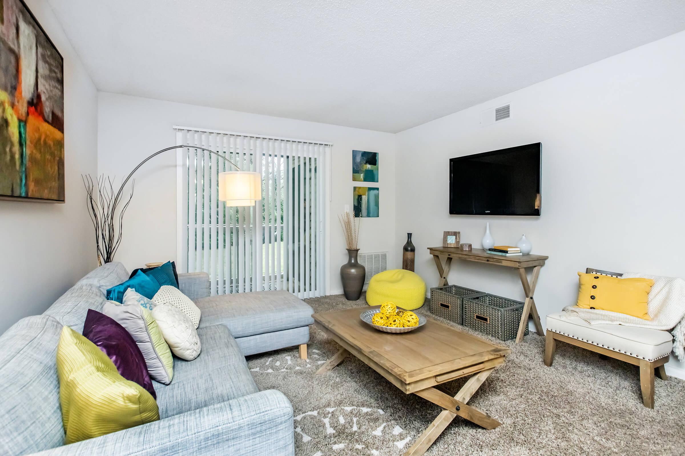 a living room filled with furniture and a flat screen tv