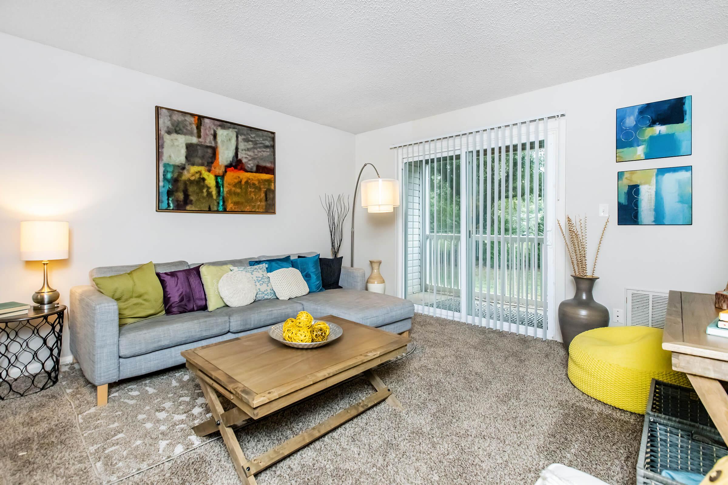 a living room filled with furniture and a flat screen tv