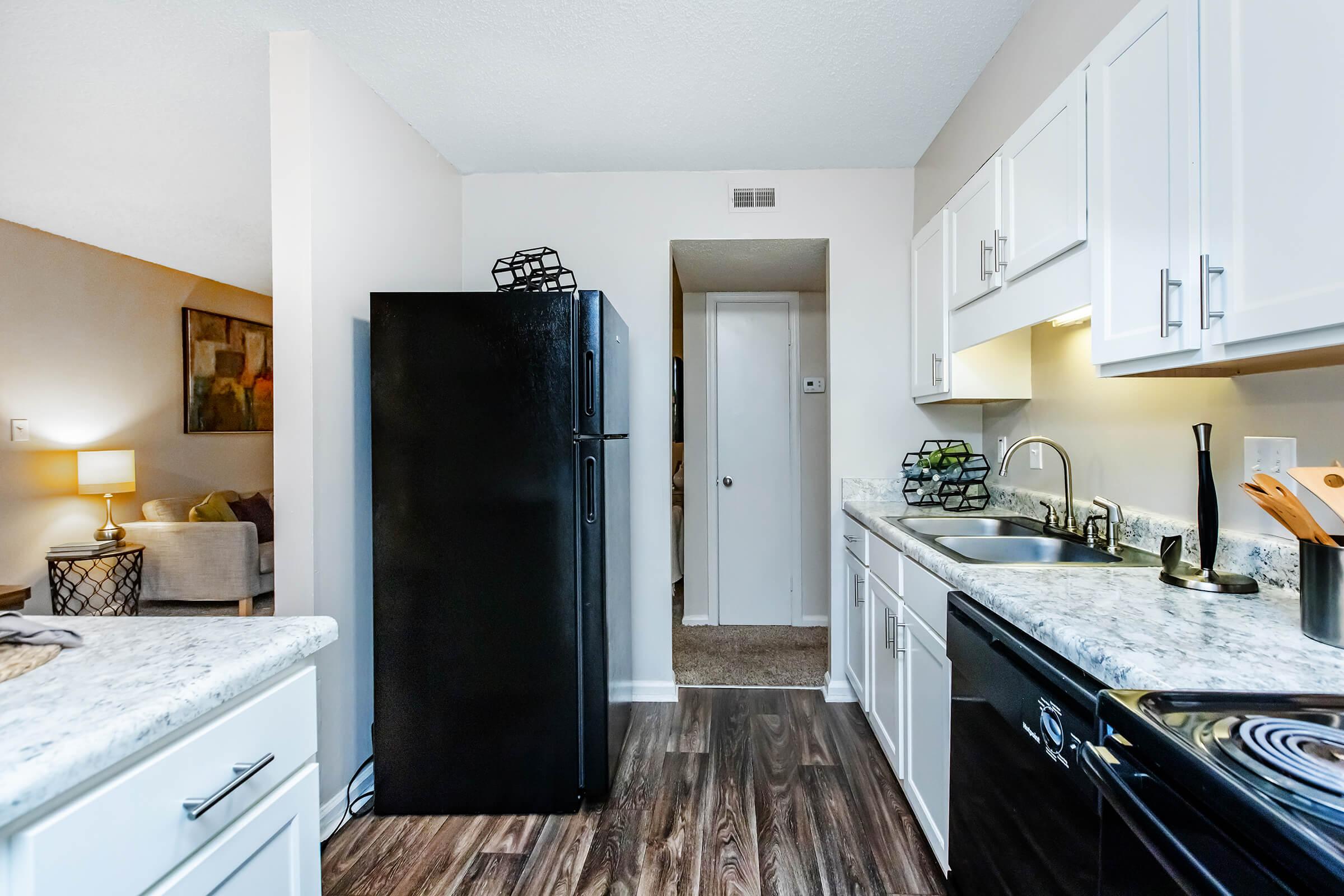 a kitchen with a stove sink and refrigerator