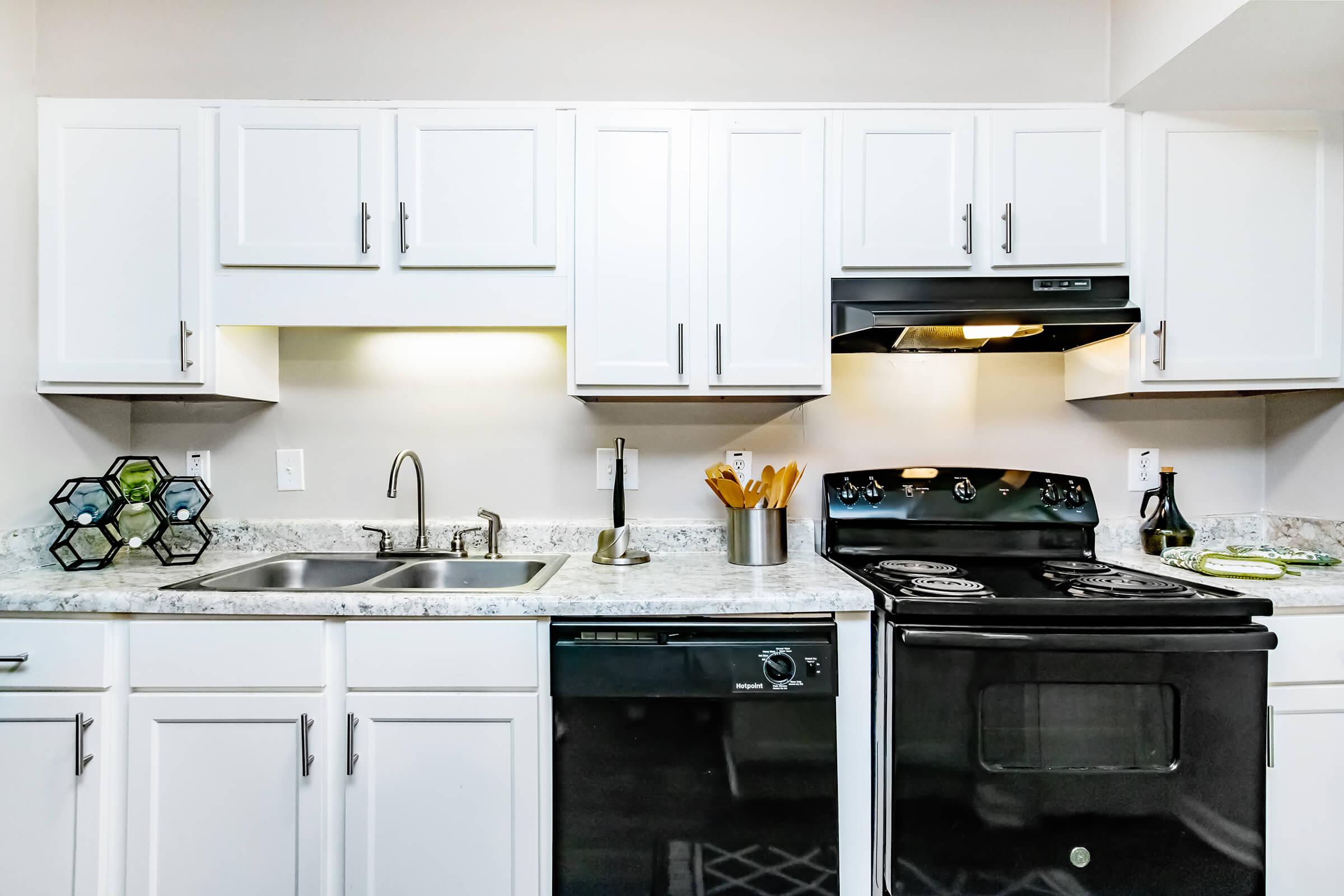 a kitchen with a stove a sink and a microwave