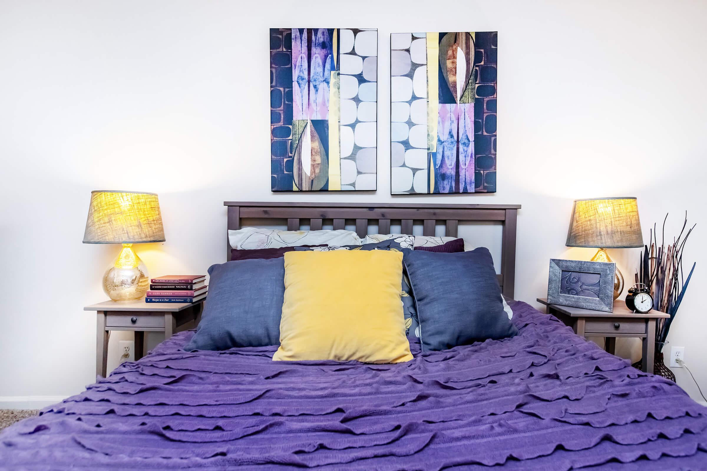 a bedroom with a bed and desk in a room